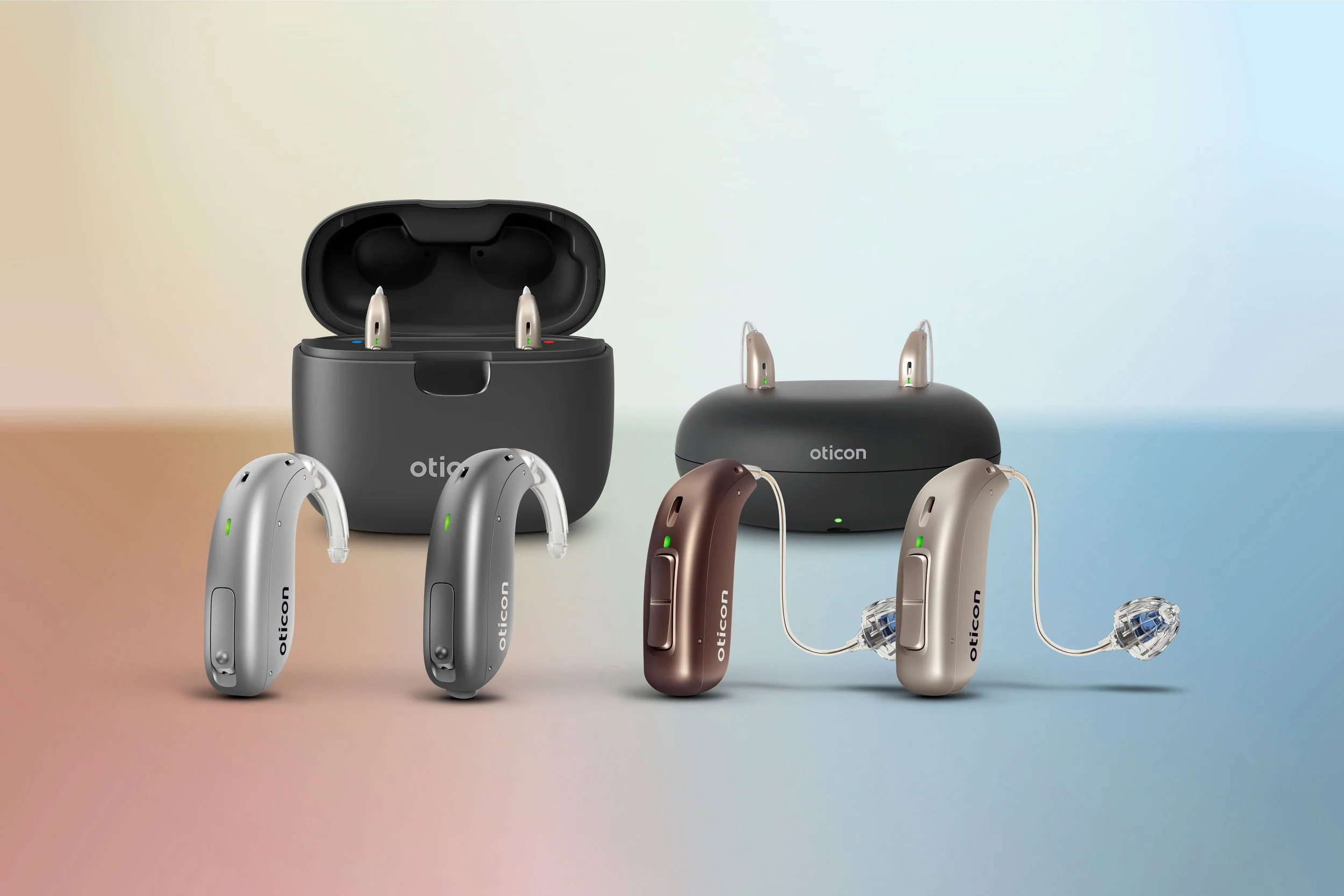 A display of Oticon hearing aids in different colors with charging cases, set against a colorful gradient background.