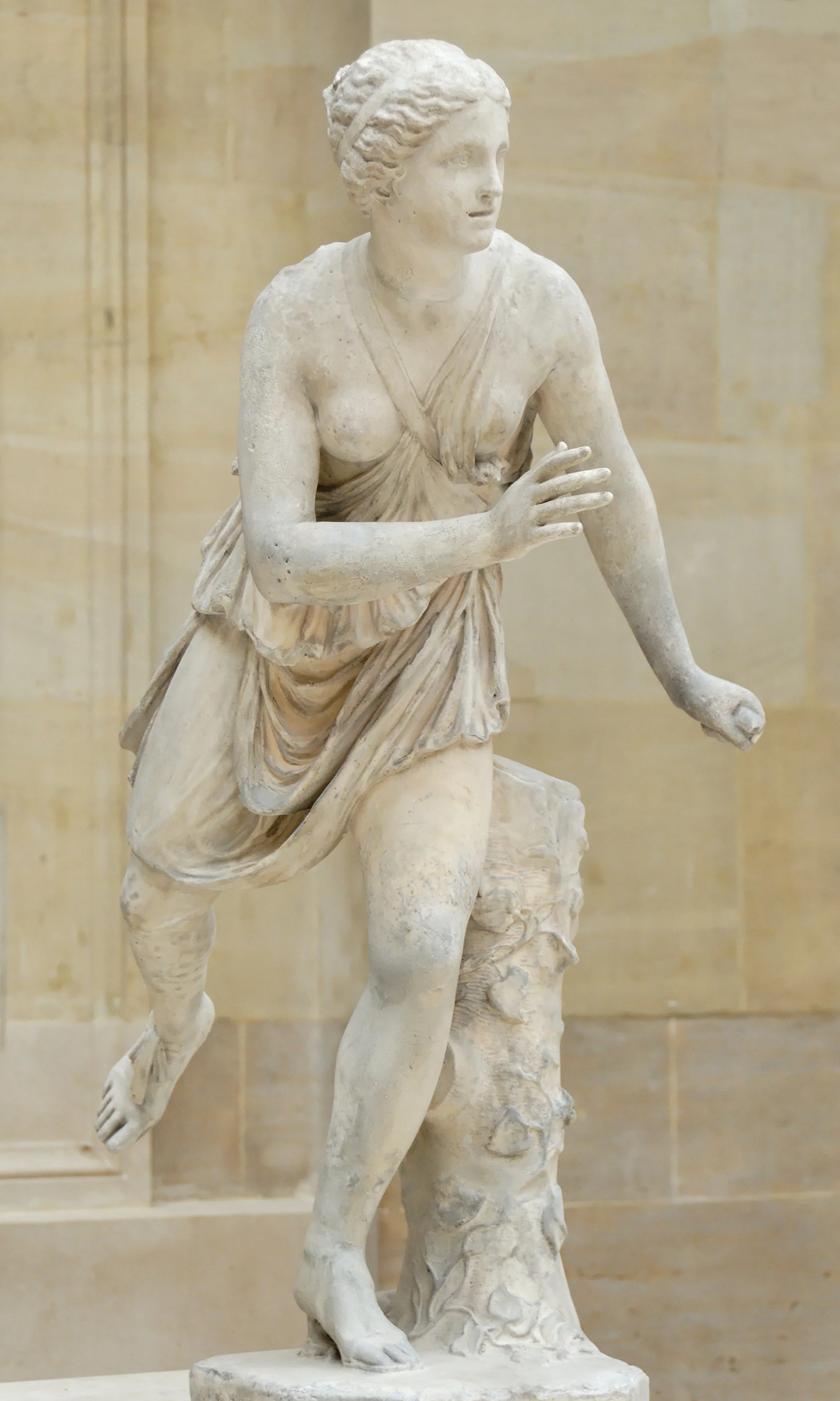 Ancient Greek marble statue of Atalanta in a running pose, believed to depict the mythological huntress and swift-footed heroine, displayed in a museum setting.