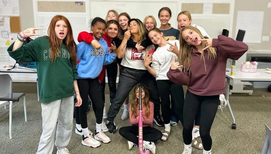 	
Women's empowerment expert Dr. Alice Atalanta pictured with the field hockey team she coaches, and everyone looks happy, joyful, empowered, and celebrating.