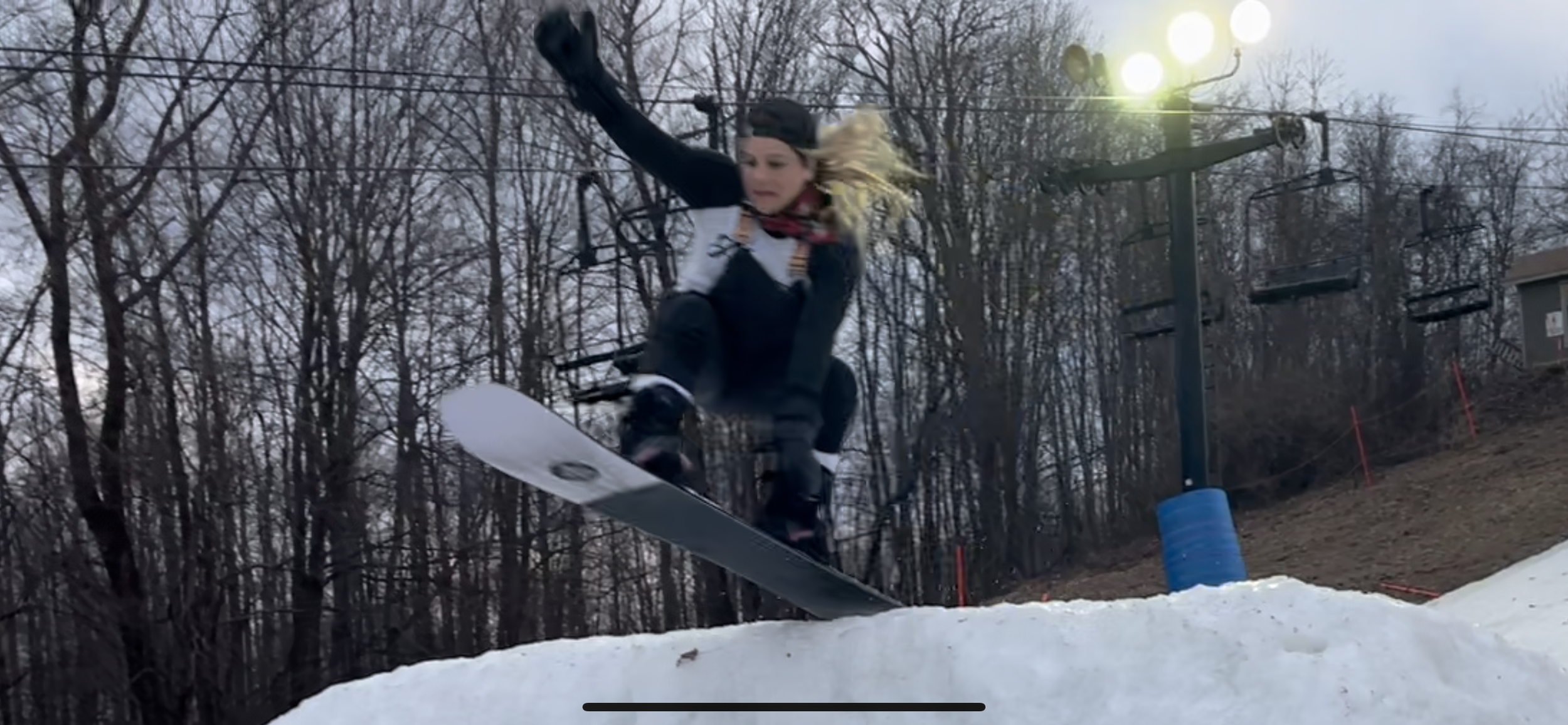 women's empowerment expert and Collegiate All-American Snowboarder for the University of Virginia (UVA) Dr. Alice Atalanta going off a snowboard jump feeling confident, strong, and brave.
