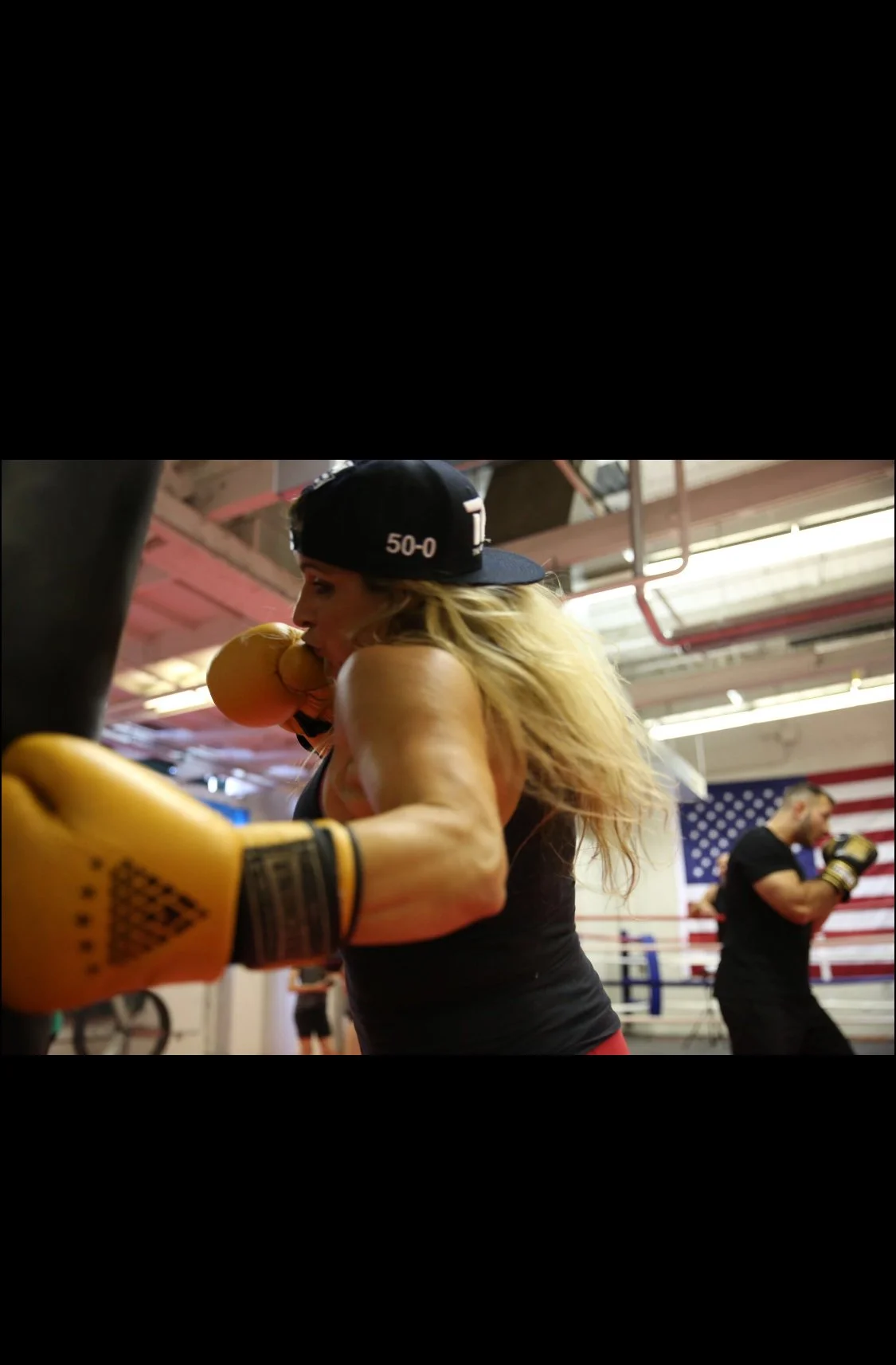 Women's empowerment expert Dr. Alice Atalanta boxing and training at her home gym, Revolution Fight & Fitness in Euclid, Ohio, owned by Tim Stafford, where she trains  mma, self-defense, and combatives.