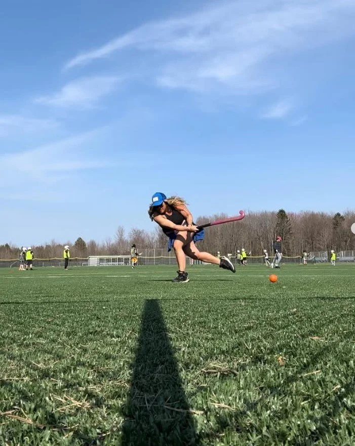 Women's empowerment expert Dr. Alice Atalanta practicing field hockey skills on the field where she trains and coaches her team, because she believes that a coach is not credible if they aren't giving their all to grow and excel.