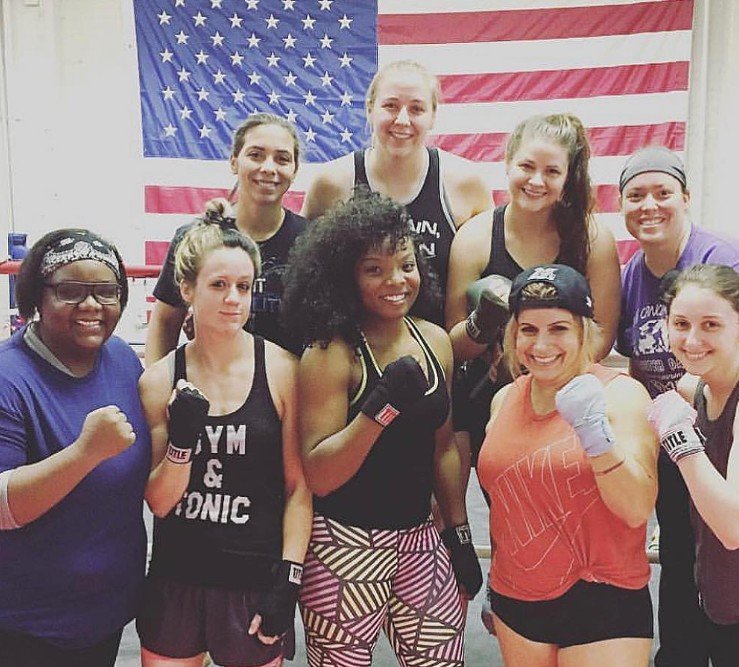 Women's empowerment expert Dr. Alice Atalanta pictured with Olympian Morelle McCane at Revolution Fight & Fitness in Euclid Ohio after a women's empowerment boxing and self-defense seminar with a group of women feeling strong and empowered
