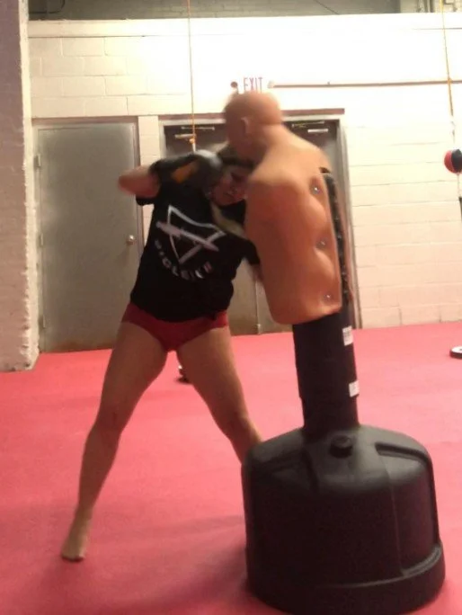 Women's empowerment expert Dr. Alice Atalanta pictured at Revolution Fight & Fitness  in Euclid Ohio while she trains combatives, boxing, and women's self-defense