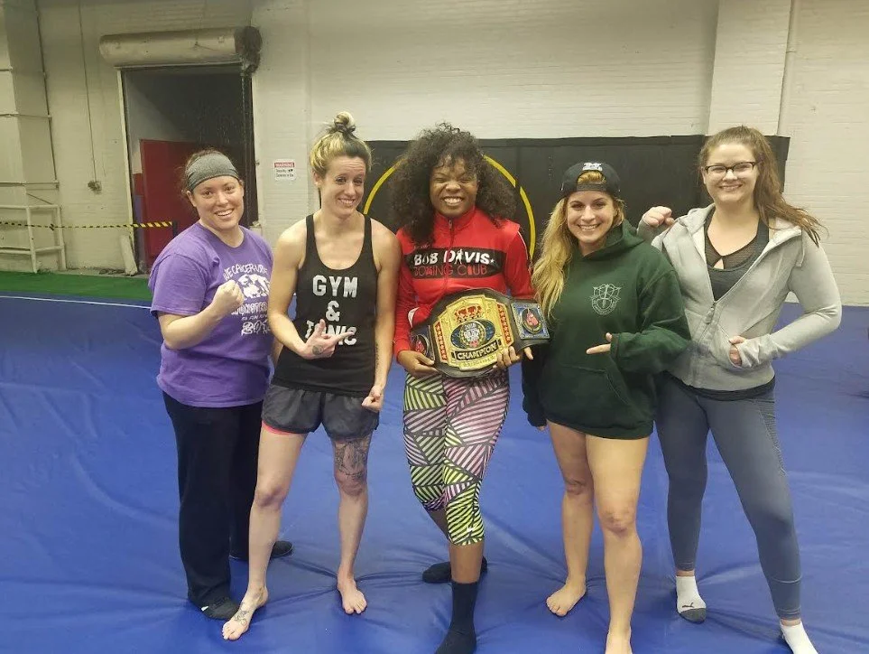 Women's empowerment expert Dr. Alice Atalanta pictured with Olympian Morelle McCane at Revolution Fight & Fitness in Euclid Ohio after a women's empowerment boxing and self-defense seminar with a group of women feeling strong and empowered