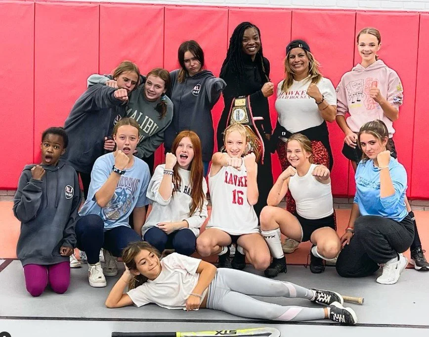 	
Women's empowerment expert Dr. Alice Atalanta with her field hockey team training in self-defense and boxing with usa boxing Olympian woman athlete Morelle McCane
