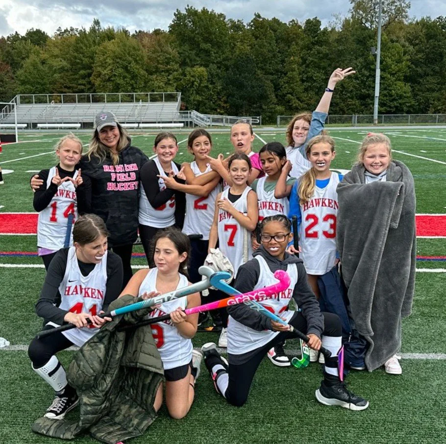 Women's empowerment expert dr. Alice atalanta with her youth field hockey team celebrating a win feeling strong, confident, joyful, and sisterhood