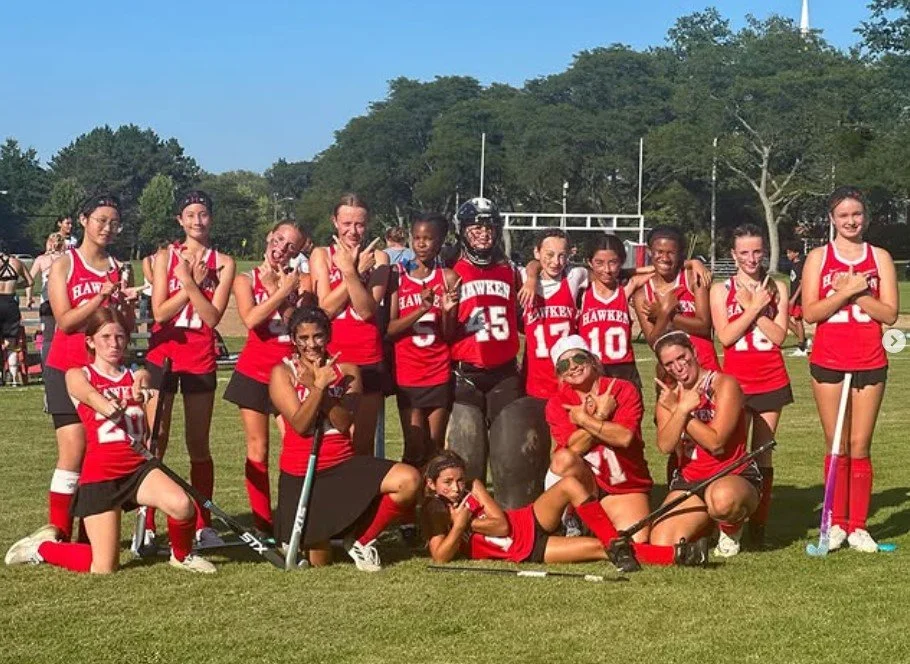 Women's empowerment expert dr. alice atalanta pictured with the field hockey team she coaches as they celebrate a win feeling empowered, joyful, confident, powerful, and athletic.