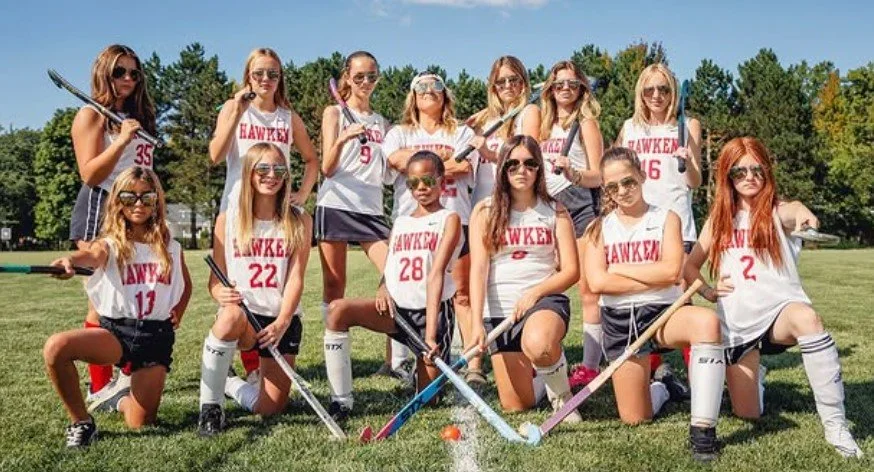 Women's empowerment expert dr. alice atalanta pictured with the field hockey team she coaches as they celebrate a win feeling empowered, joyful, confident, powerful, and athletic.