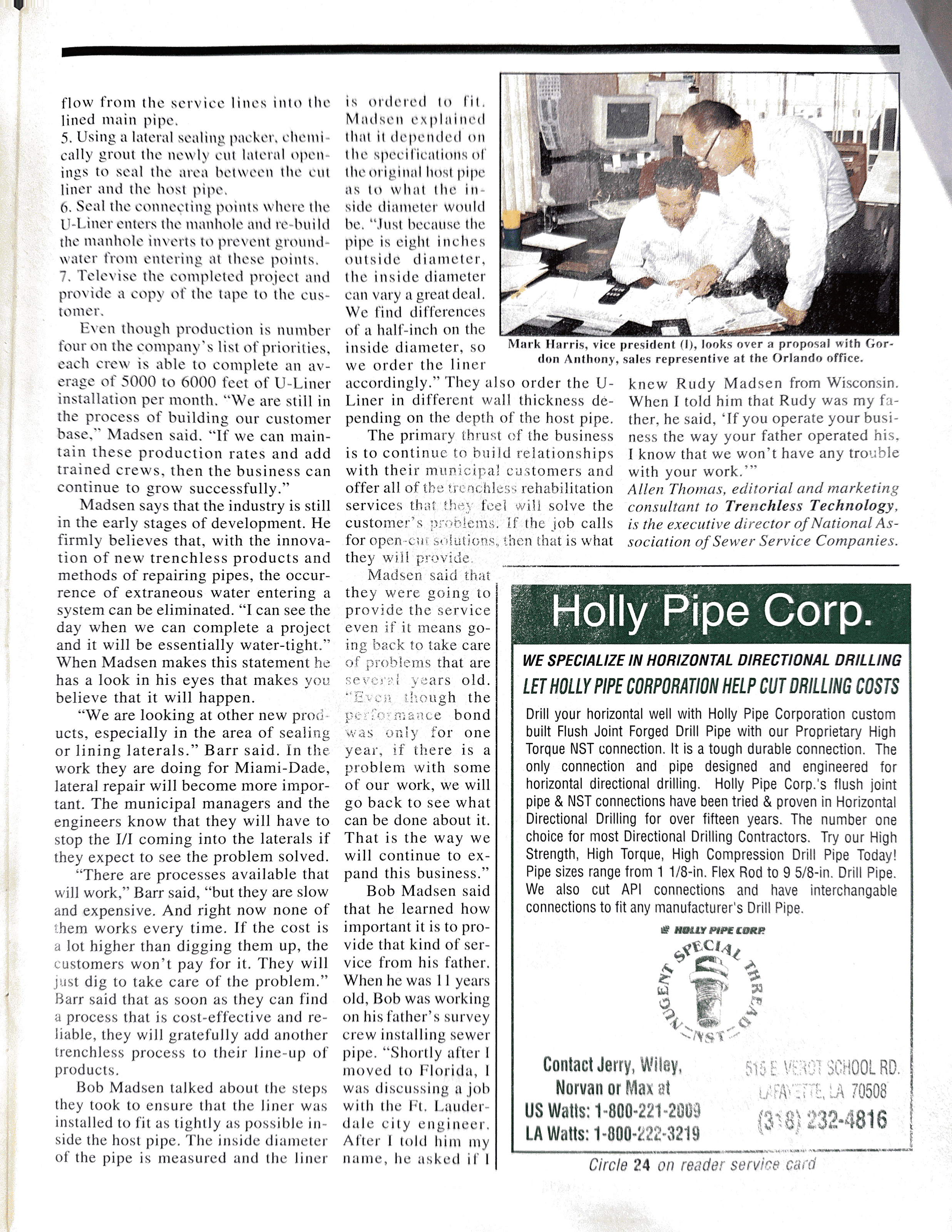 A newspaper page with a small photo of two men in a discussion, one seated at a desk and the other standing, both in business attire. The article contains text about pipe installation and a section for Holly Pipe Corp., including contact information and a logo.