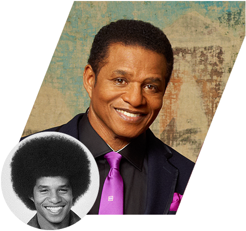 A smiling African American man in a dark suit with a purple tie and pocket square, against a textured background, with an inset black-and-white image of his younger self with an afro hairstyle.