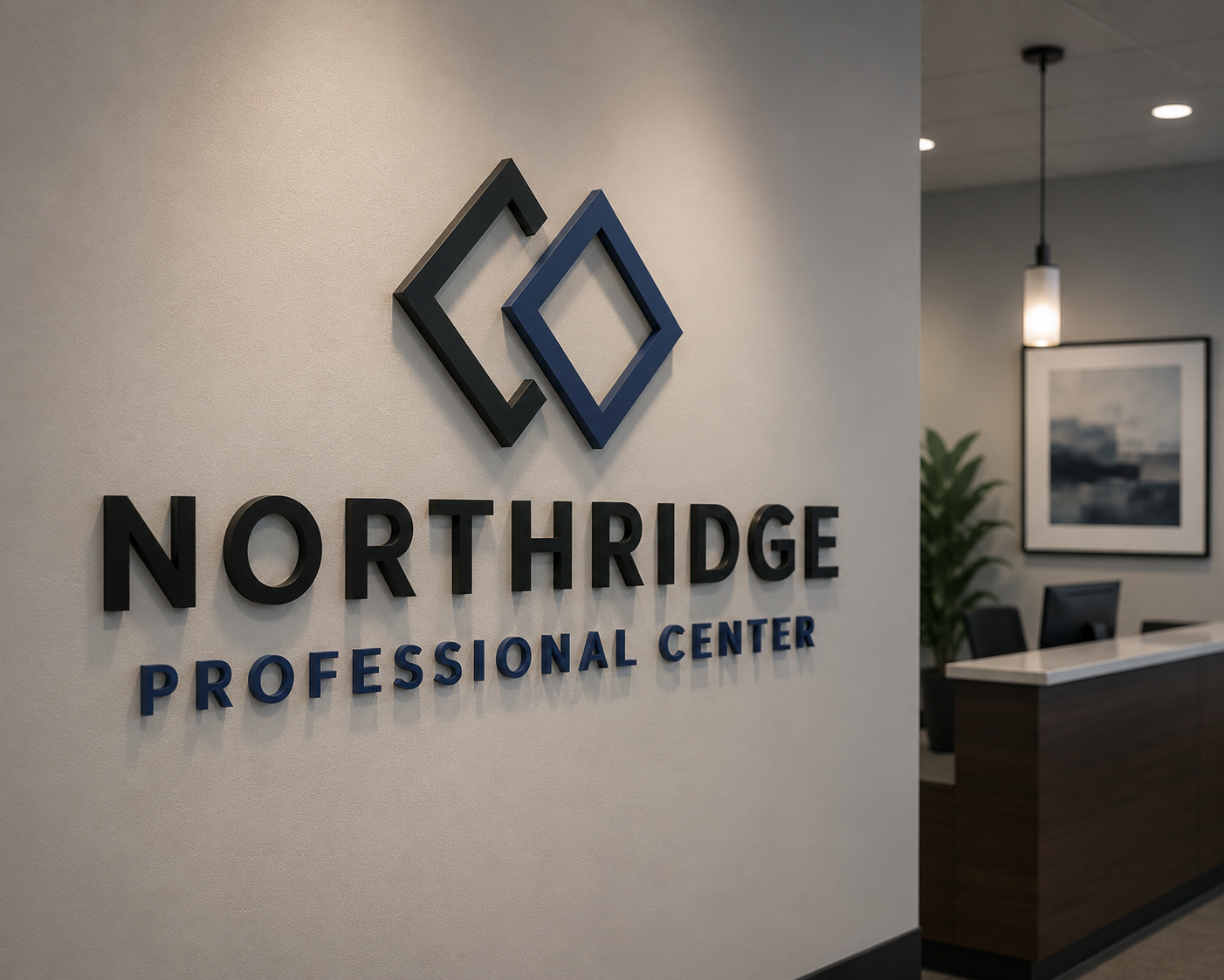 Interior view of the reception area at Northridge Professional Center, featuring the center's logo on the wall, a reception desk, indoor plants, a framed picture, and modern lighting.