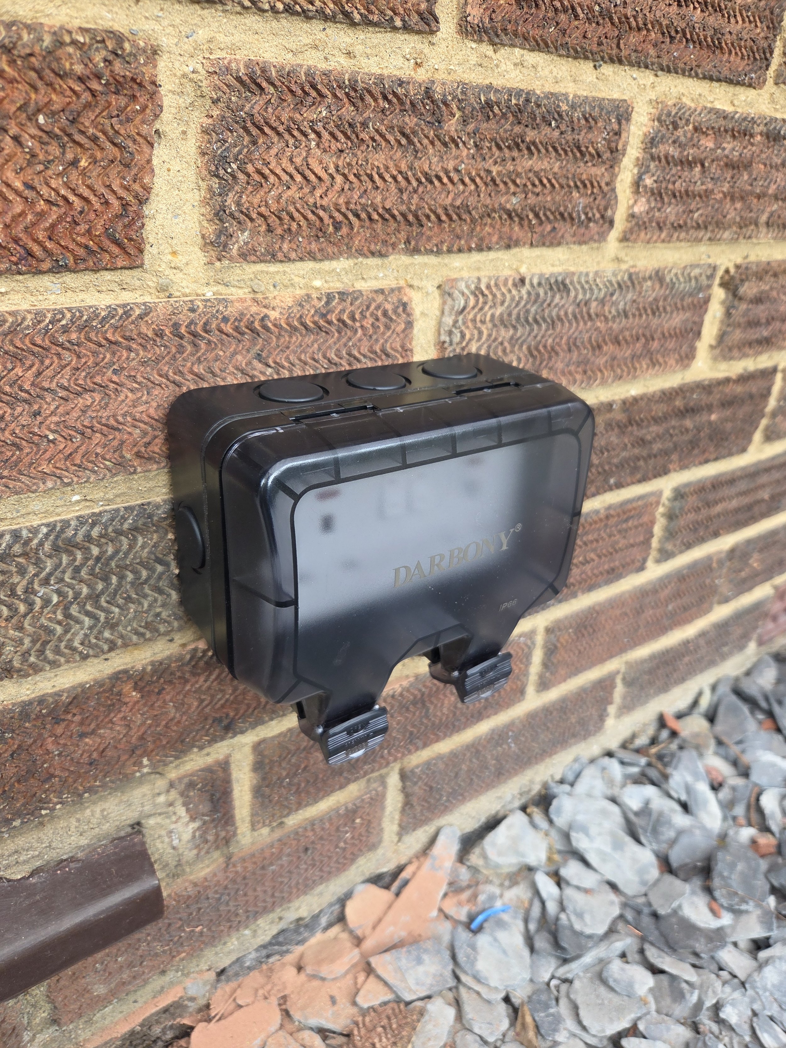 External socket mounted to a brick wall in Potters Bar