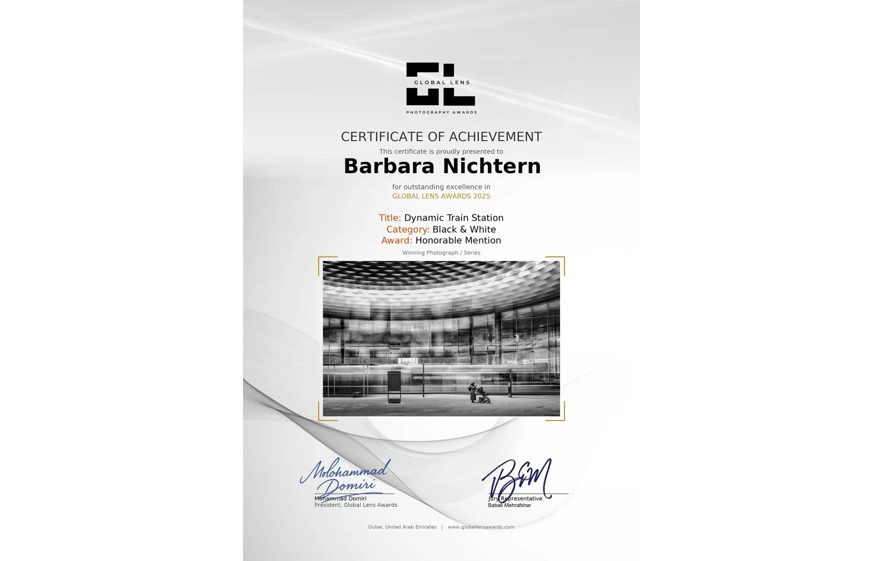 Certificate of achievement awarded to Barbara Nichtern for outstanding excellence in the Global Lens Awards 2025, featuring a black and white photograph of a modern train station with a person walking and a child in a stroller.