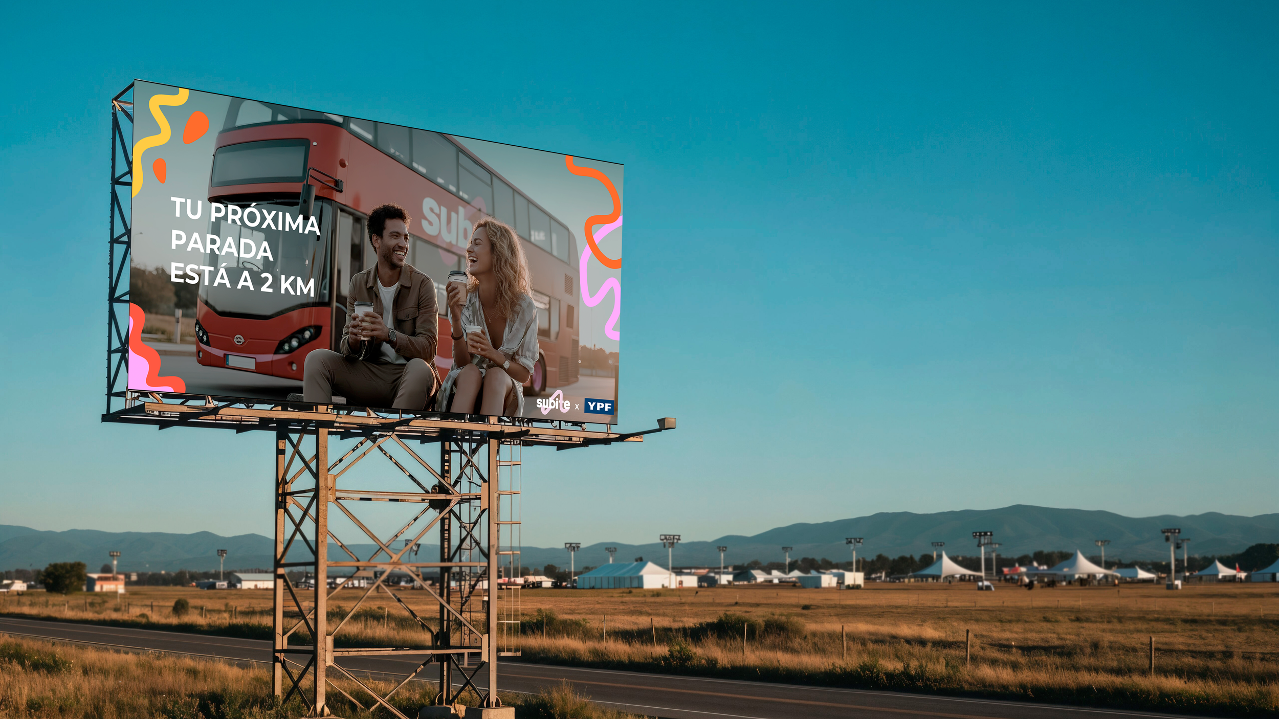 Billboard showing a man and woman smiling and talking while holding coffee cups with a red bus in the background and colorful abstract decorations in the corners, set against a clear blue sky.