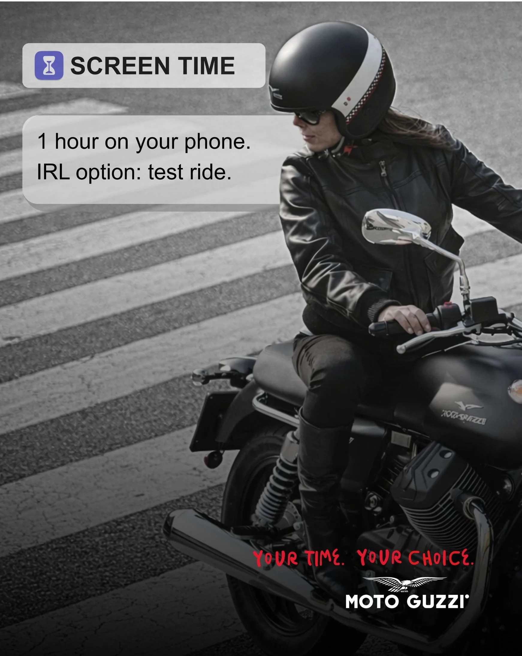 A person wearing a black motorcycle helmet, sunglasses, and a black leather jacket is riding a motorcycle across a pedestrian crosswalk. The image features text that says, 'Screen Time,' and a message about limiting phone use, along with the Moto Guzzi logo.