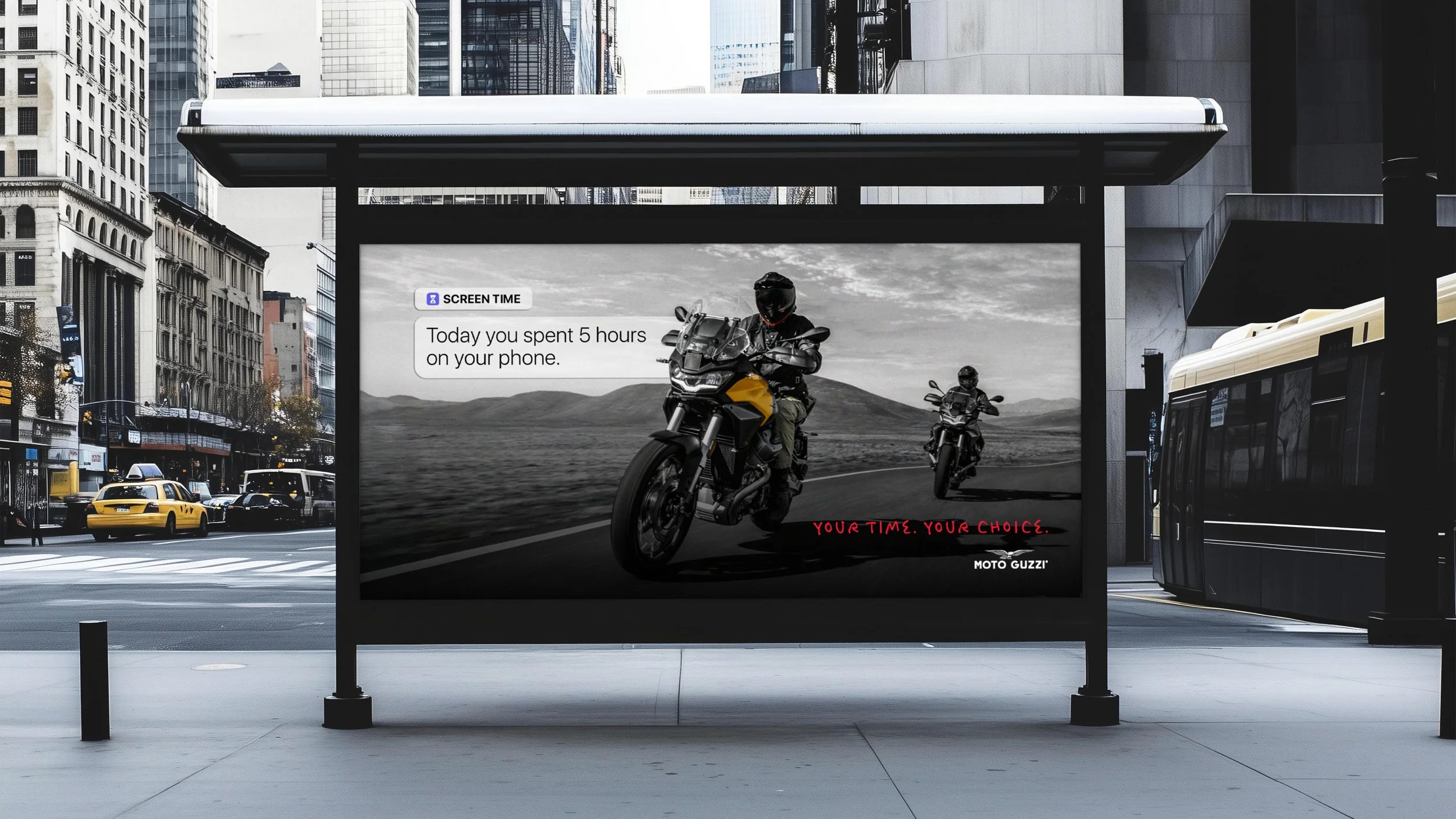 City street scene with buildings, taxis, and a bus. A digital billboard displays two motorcyclists riding on a road, with text indicating screen time and a motivational message.