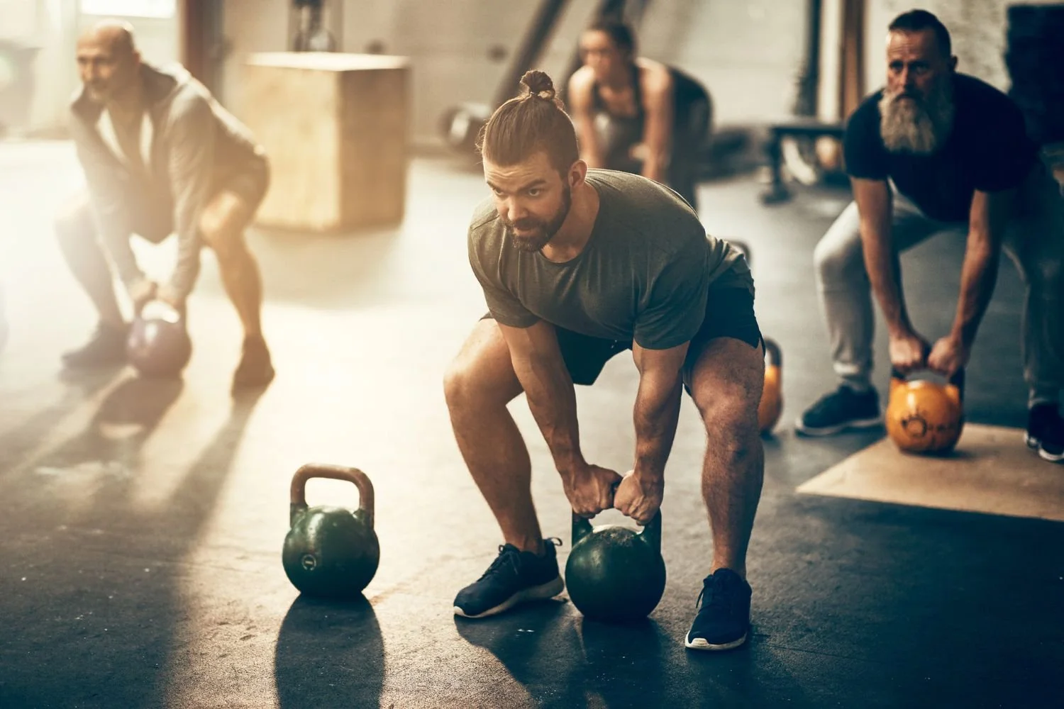 Group performing kettlebell exercises during a strength-training session