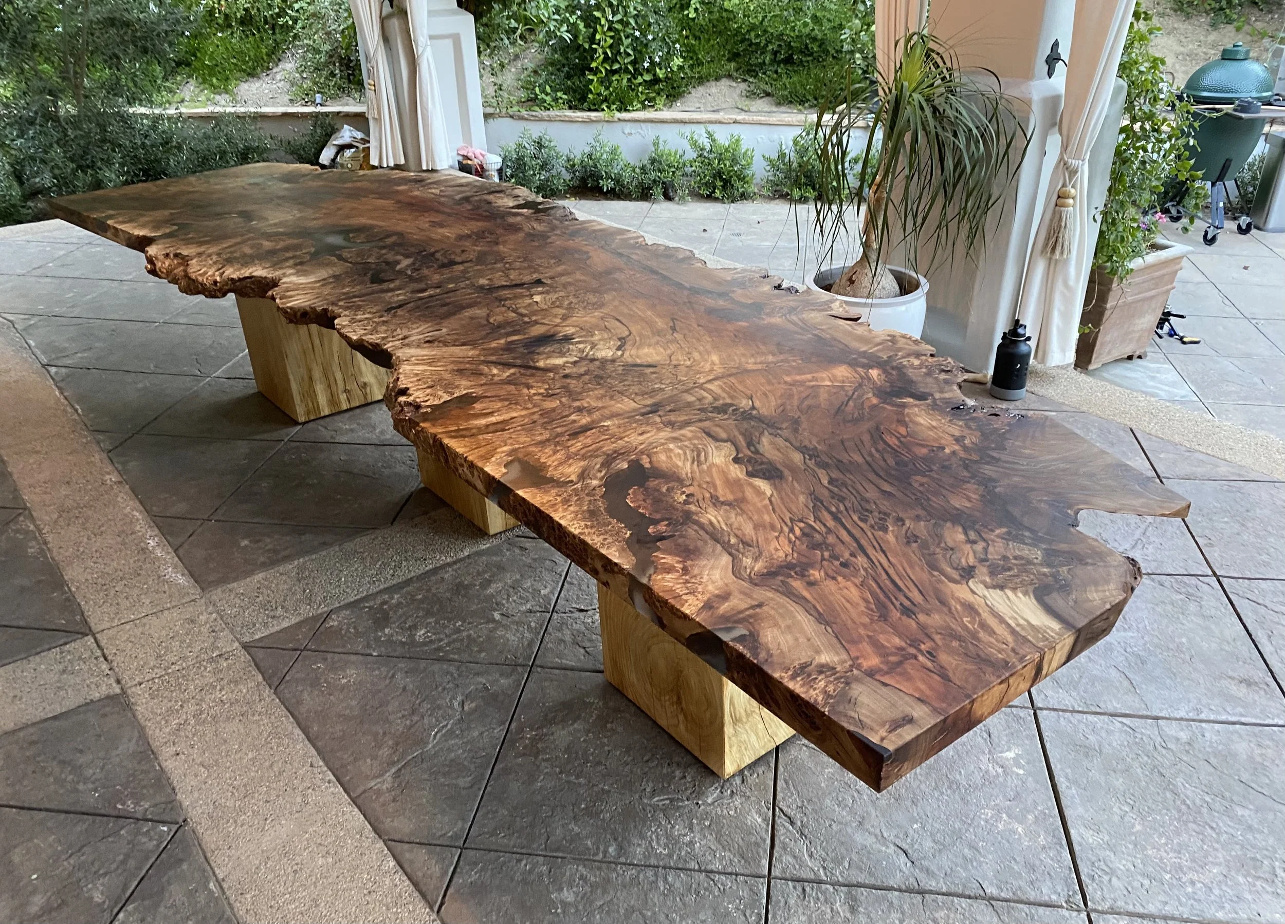 A large custom wood and epoxy outdoor table