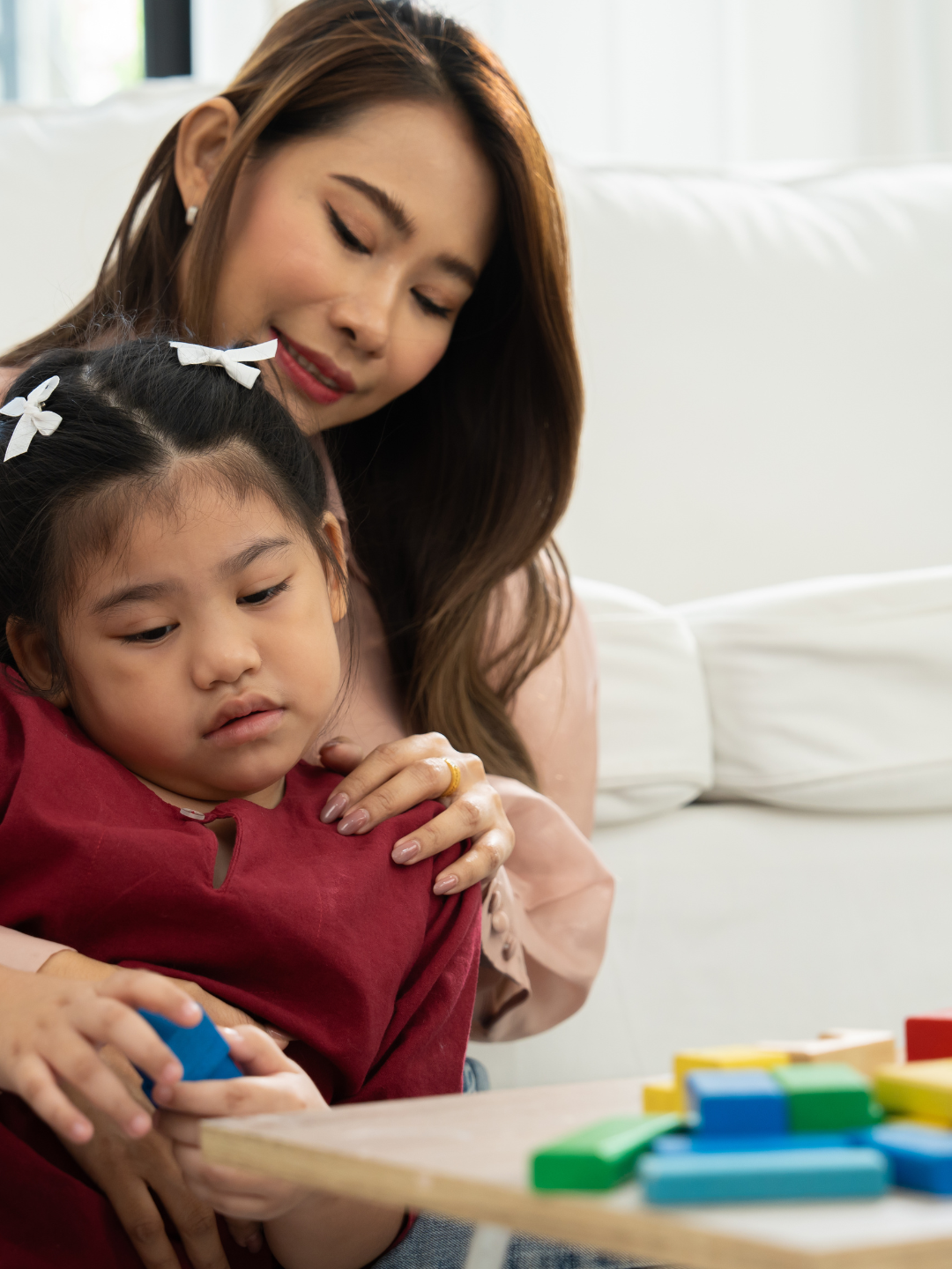 An ABA therapist conducting a structured and warm therapy session with a child with Down Syndrome, using visual supports and reinforcement-based teaching strategies