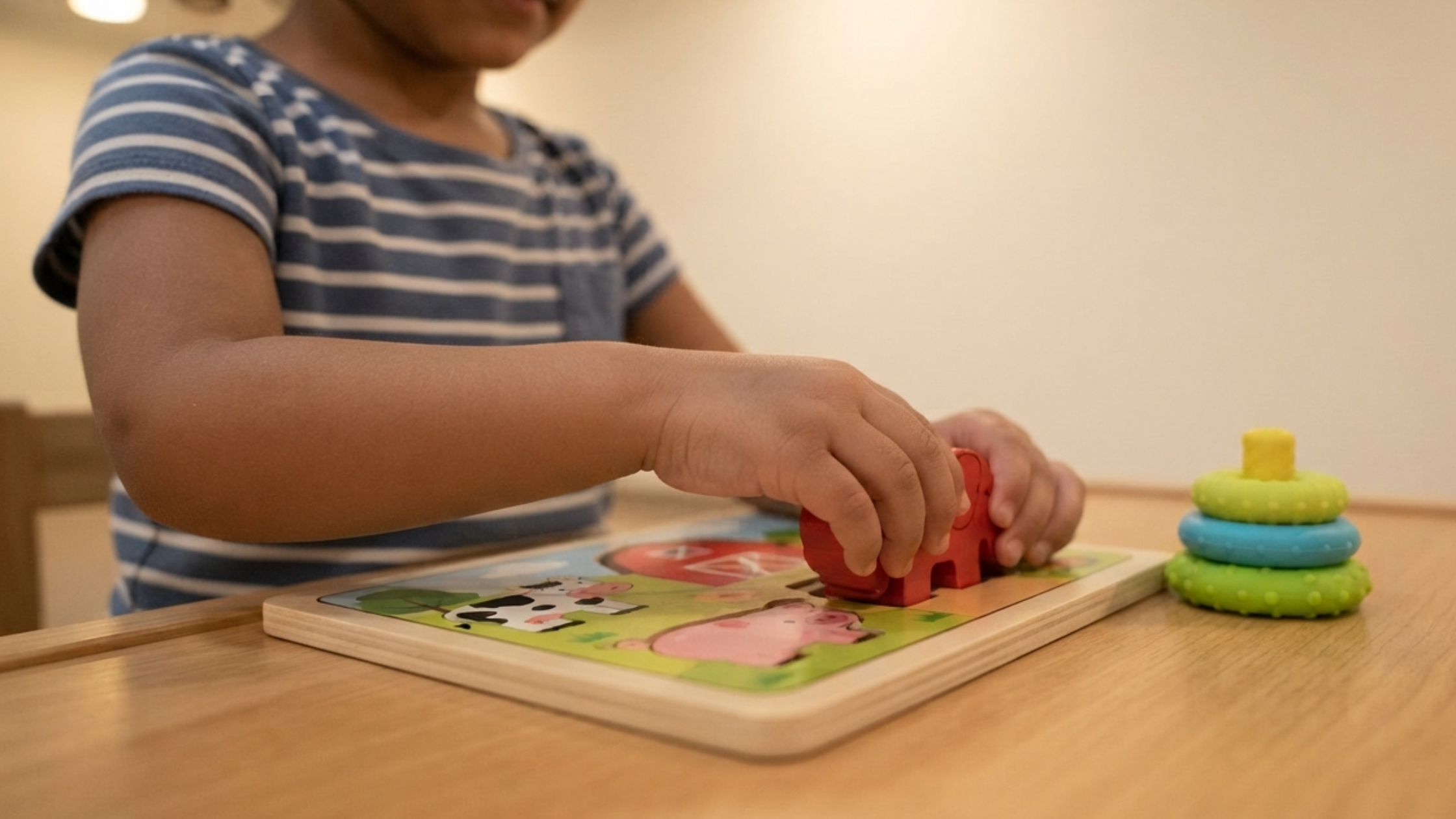 A NeuroCore ABA therapist using positive reinforcement during a structured session with a child, offering immediate praise after a successful attempt