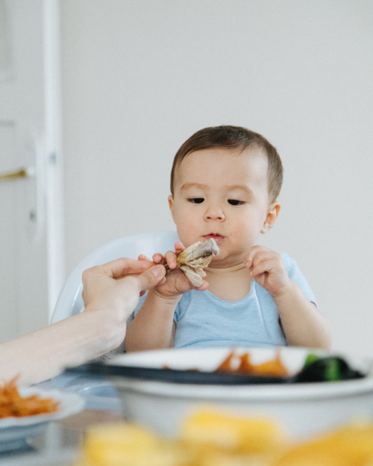 Child engaging in sensory food exploration as part of NeuroCore's ABA feeding support