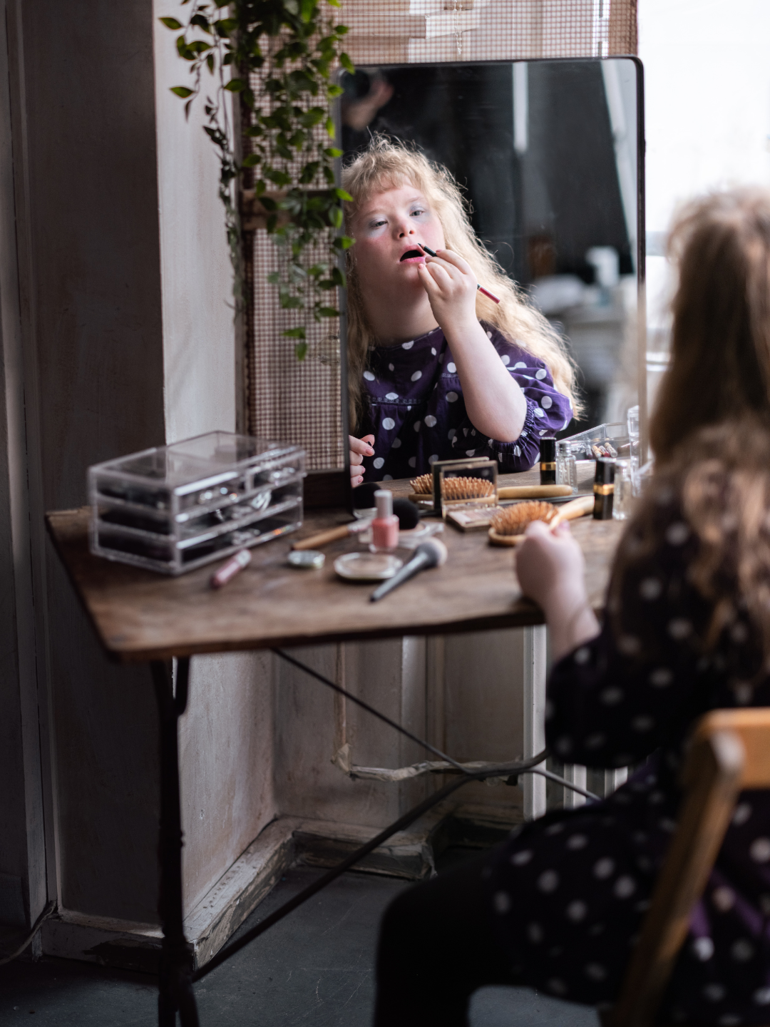 A child with Down Syndrome working independently on a daily living skill at home in Dubai, supported by ABA strategies from NeuroCore