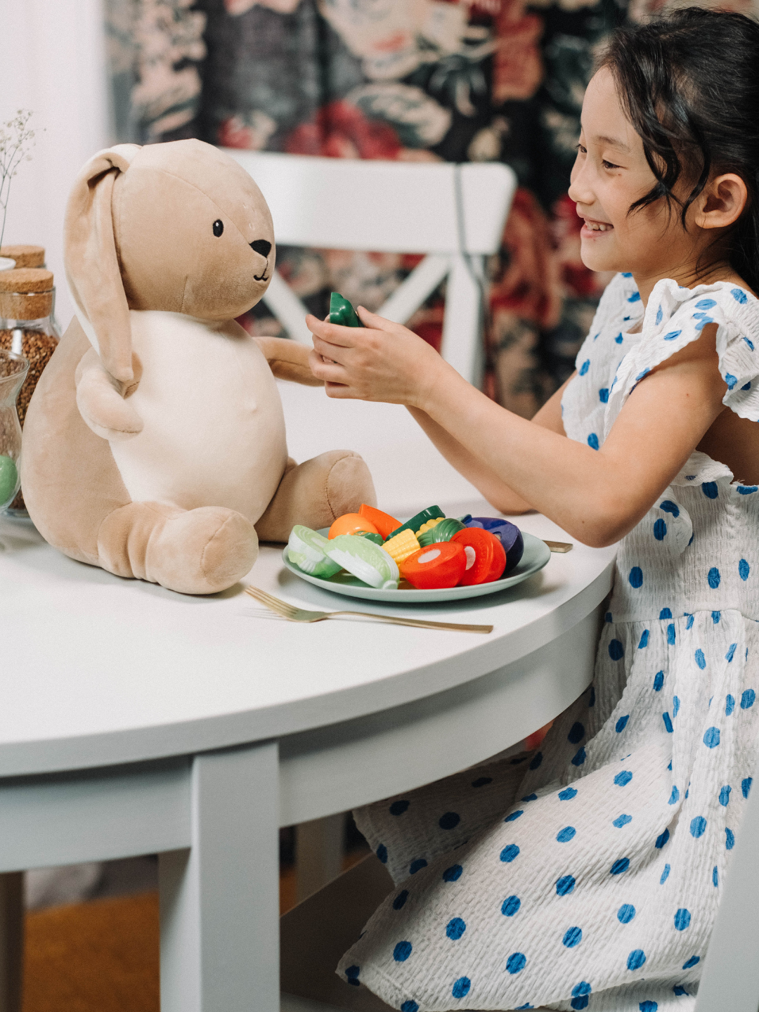 An ABA therapist using naturalistic teaching during a play-based session with a child, embedding learning into a natural everyday activity at home