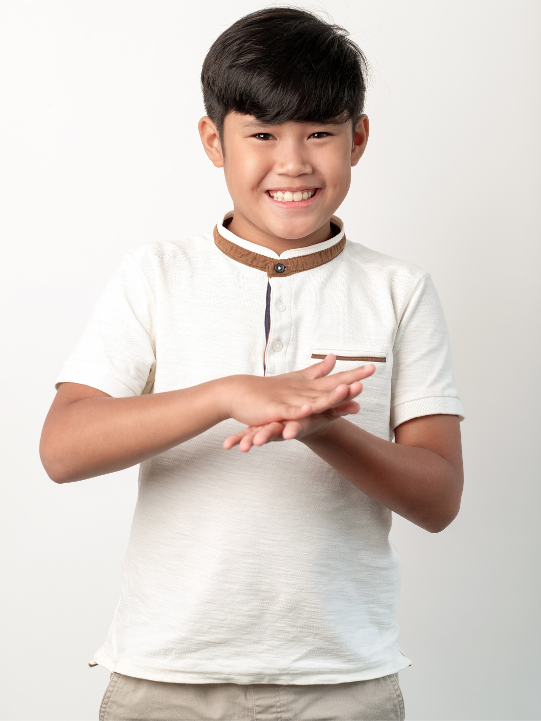 A child with hearing loss using sign language to communicate during an ABA therapy session in Dubai, supported by a NeuroCore therapist