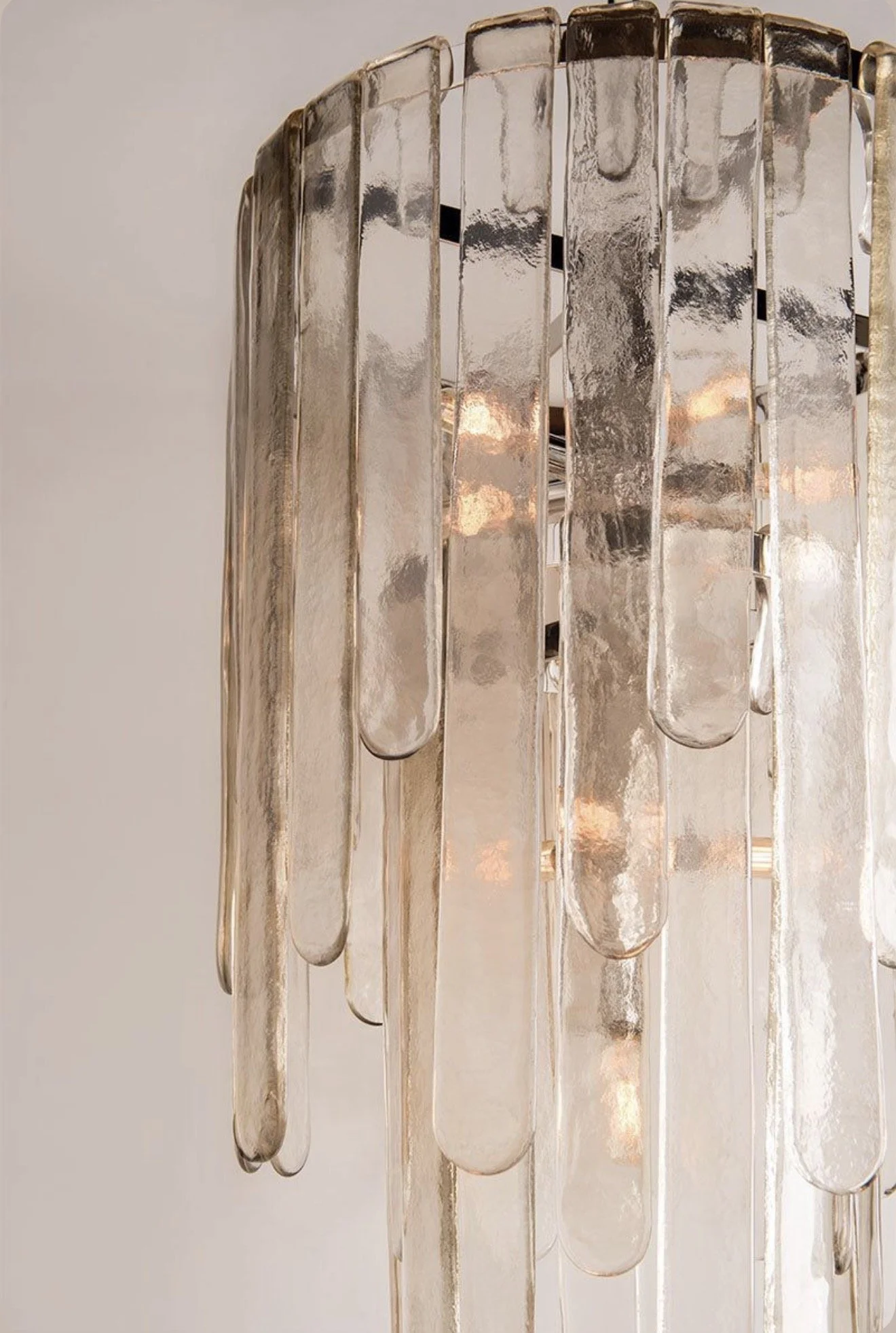 Modern statement chandelier featuring vertical frosted glass tubes and a circular frame, adding elegant lighting to a contemporary Mesa, Arizona home interior.