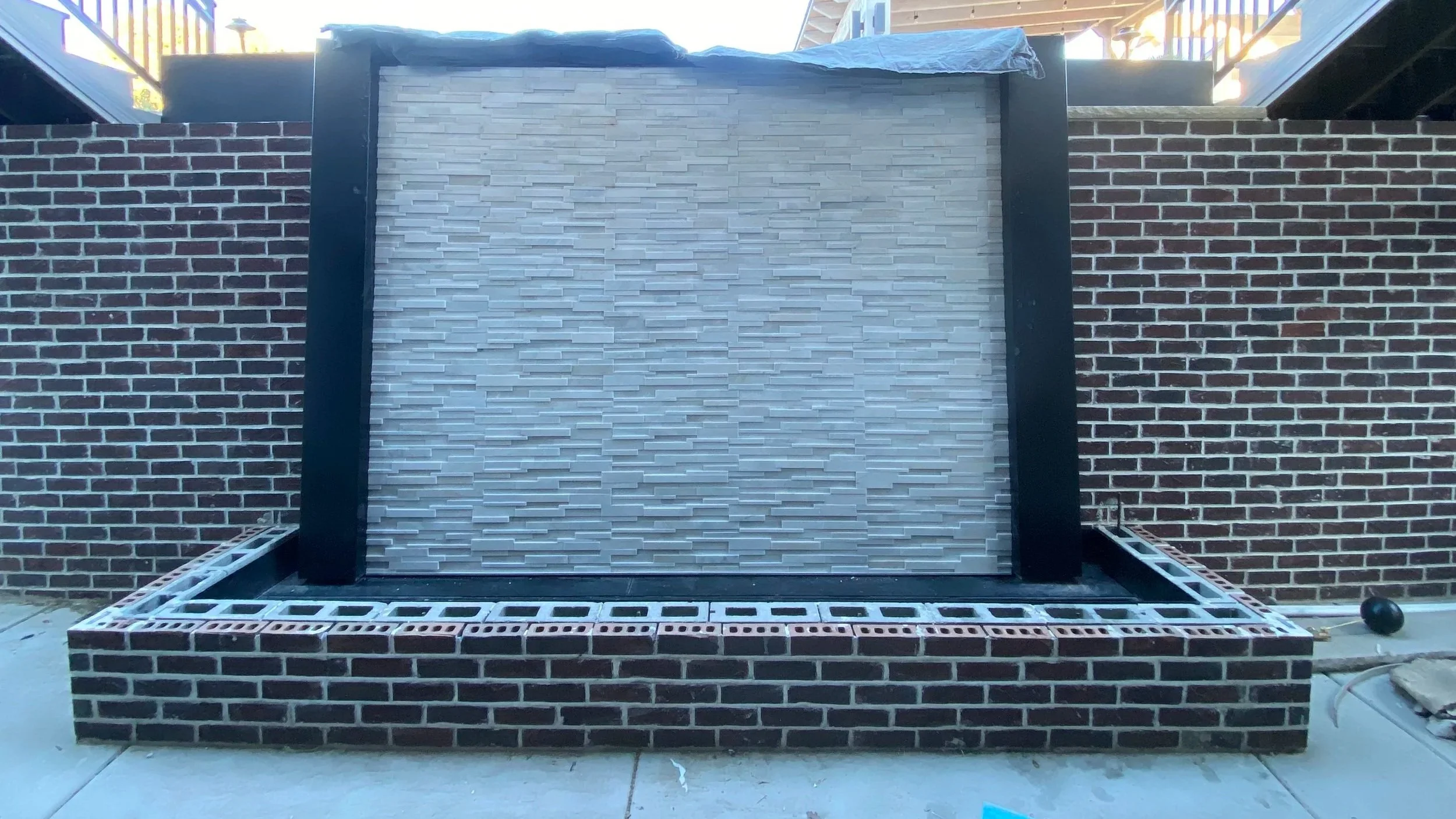 High-end decorative water feature tile installation featuring premium finishes in Salt Lake and Utah County.