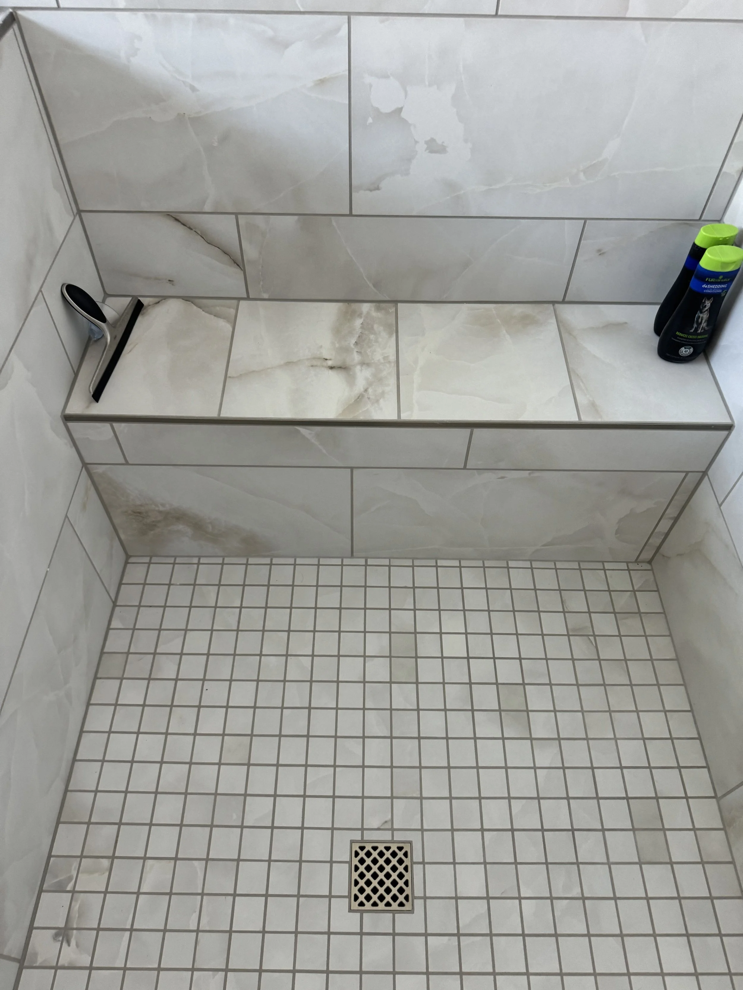 Intricate custom shower tile work with perfect alignment and luxury finishes by ANB Construction.