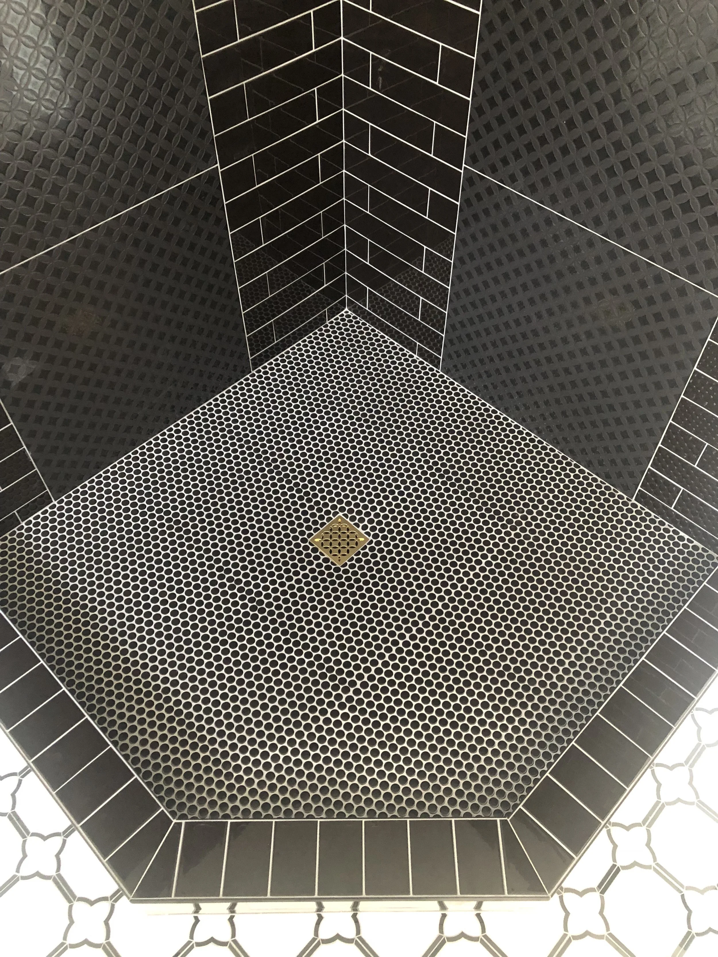 Intricate custom shower tile work with perfect alignment and luxury finishes by ANB Construction.