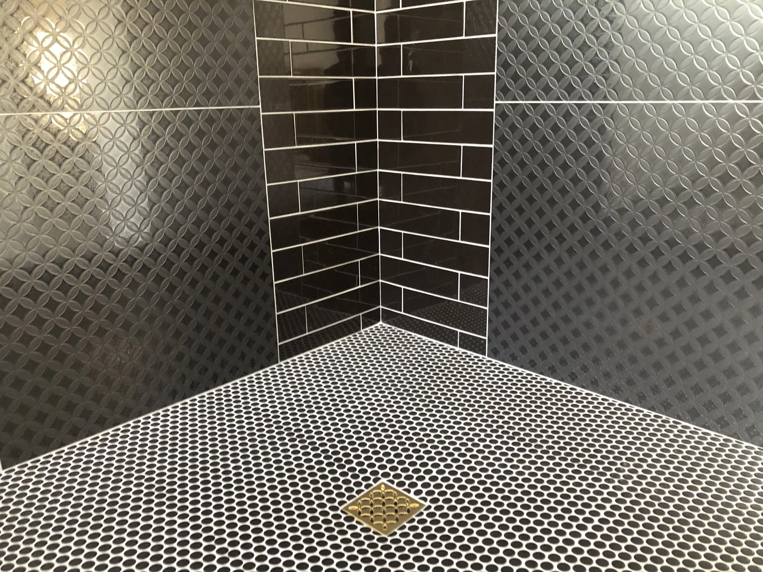 Intricate custom shower tile work with perfect alignment and luxury finishes by ANB Construction.