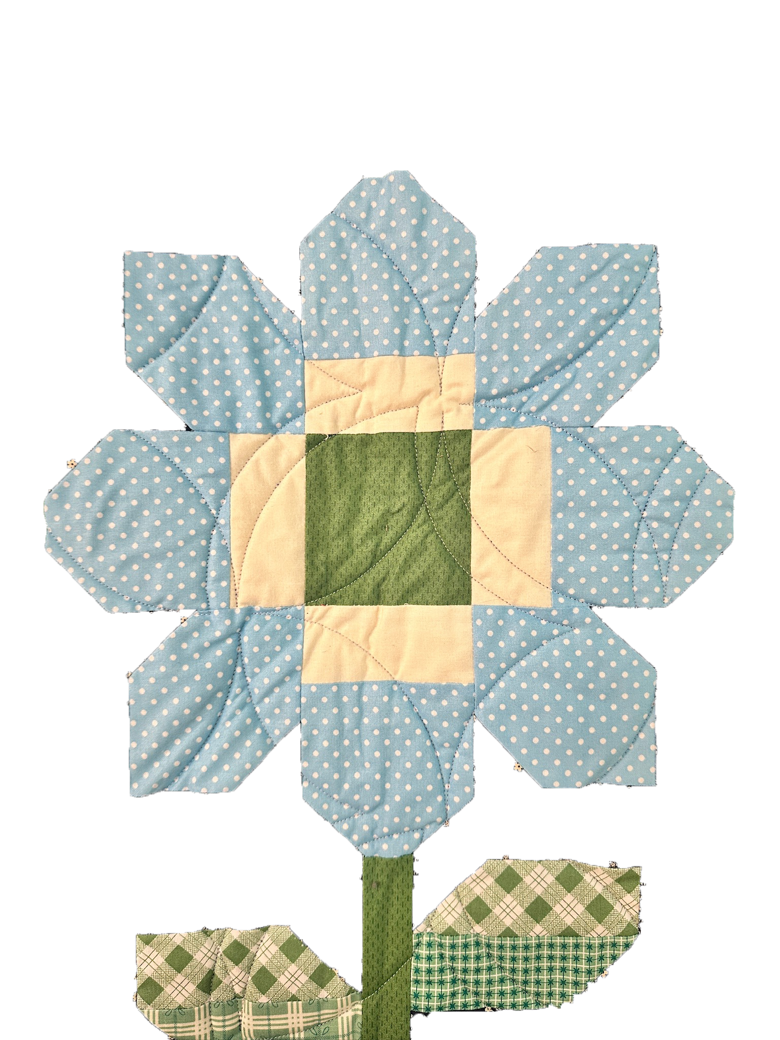 A quilted fabric sunflower wall hanging with a green stem and green leaves, surrounded by small green and beige checkered fabric flowers.