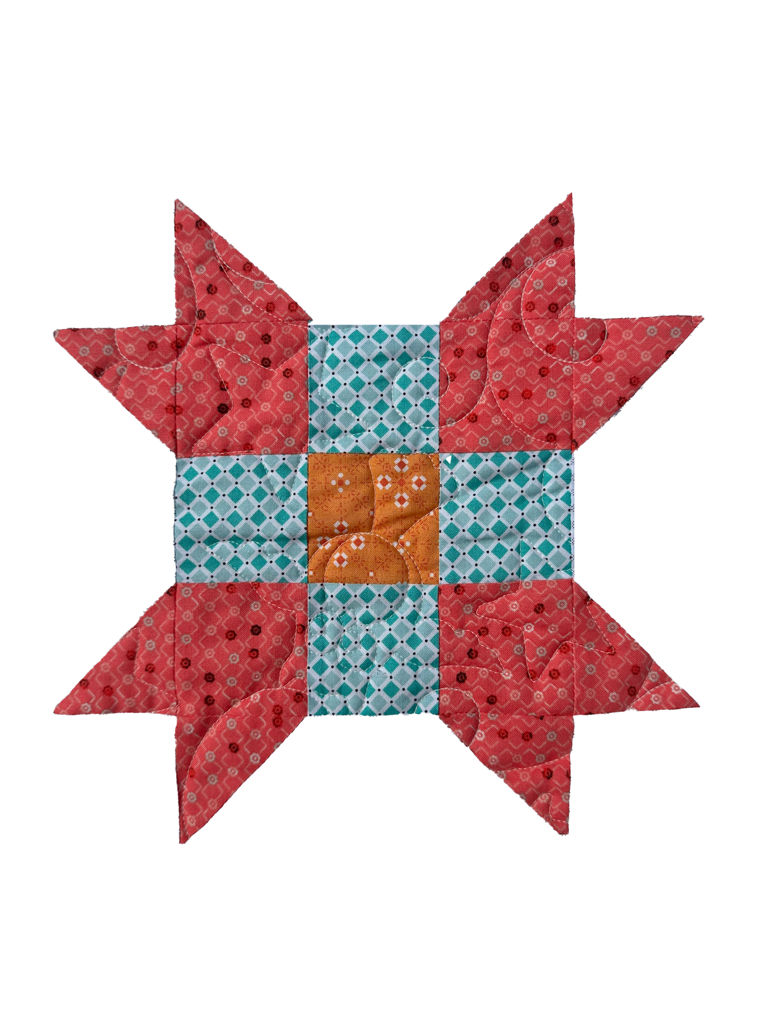 A colorful quilt featuring a fox design, with a patterned body, pointed ears, and a orange snout, set against a background of various geometric and floral fabric patterns.