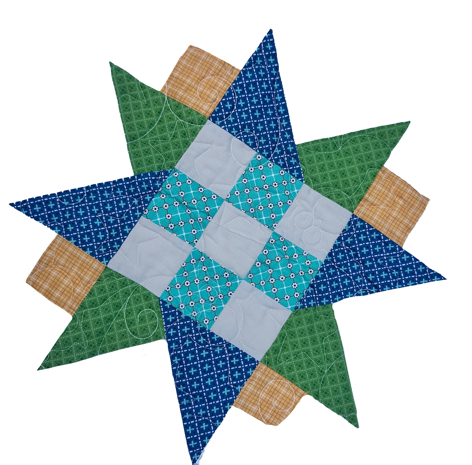 A colorful quilt with a star pattern, featuring various pieces of fabric with different patterns and colors including blue, green, beige, and white.