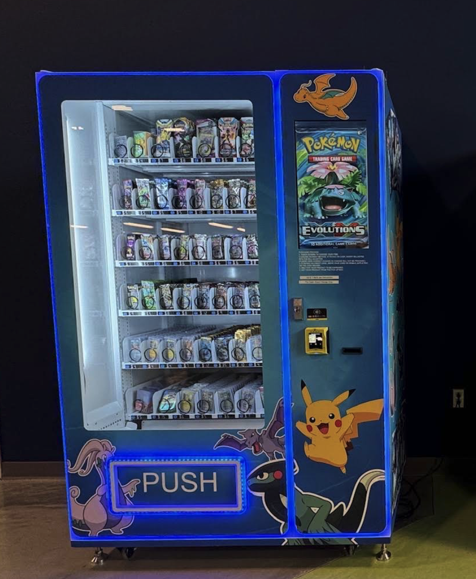 Pokémon-themed vending machine with Pokémon characters like Pikachu, Dragonite, Gengar, and Umbreon, containing Pokémon trading card packs.