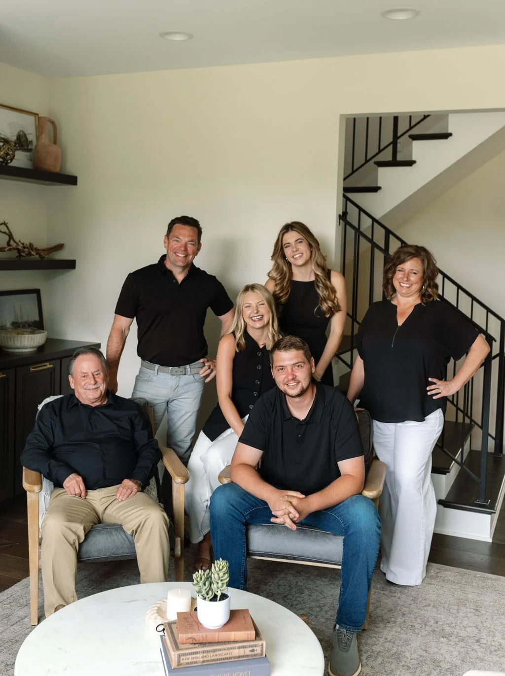 RedKnot Custom Homes team gathered in living room, smiling for a group photo.