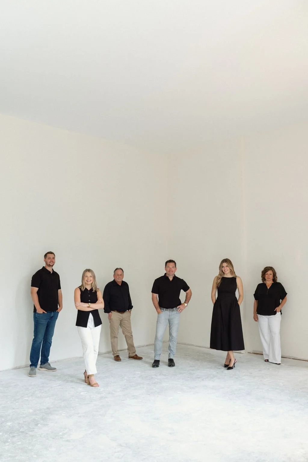 Redknot Homes team smiling for team photo in large interior space