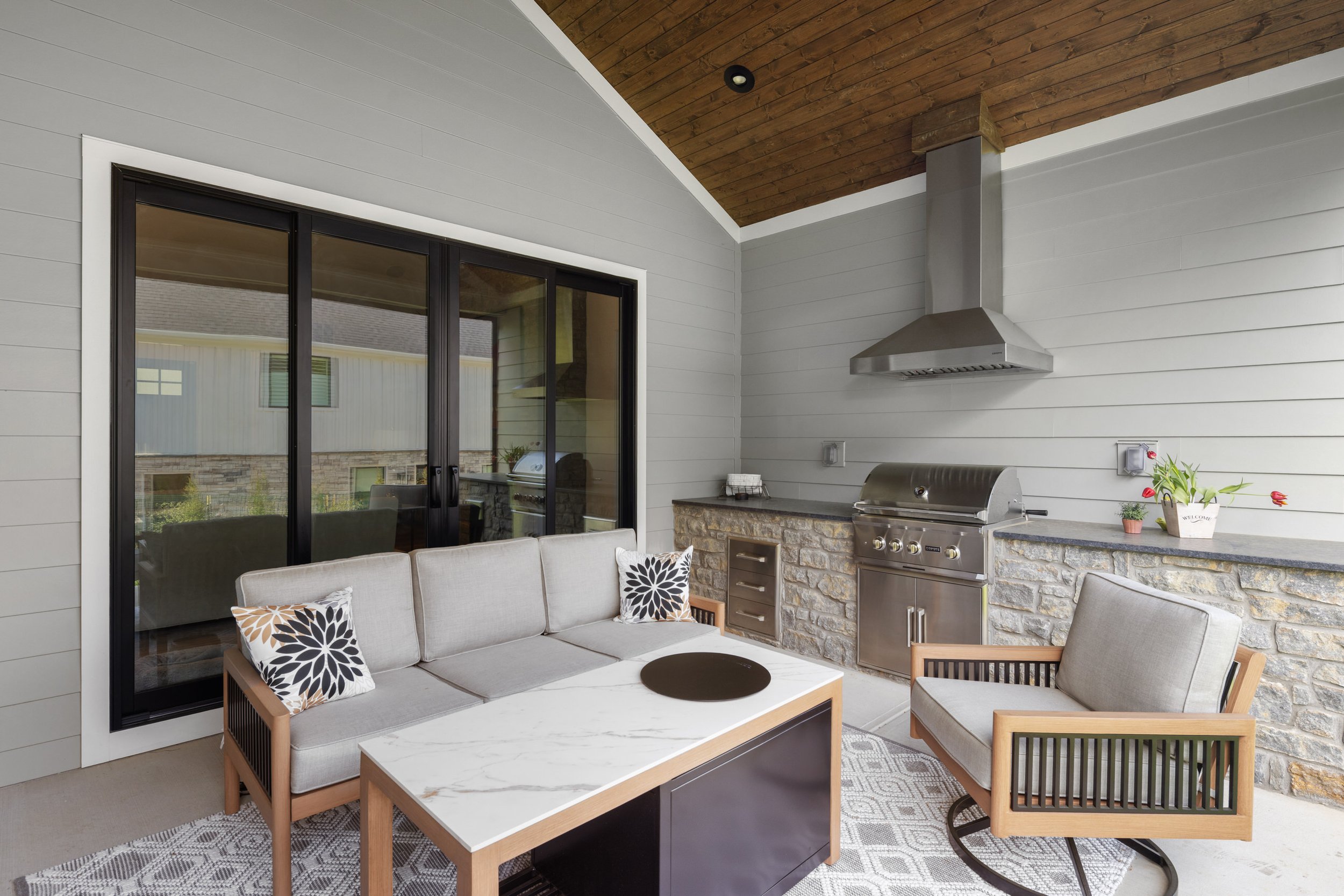 Custom outdoor space living with patio, couch and grill
