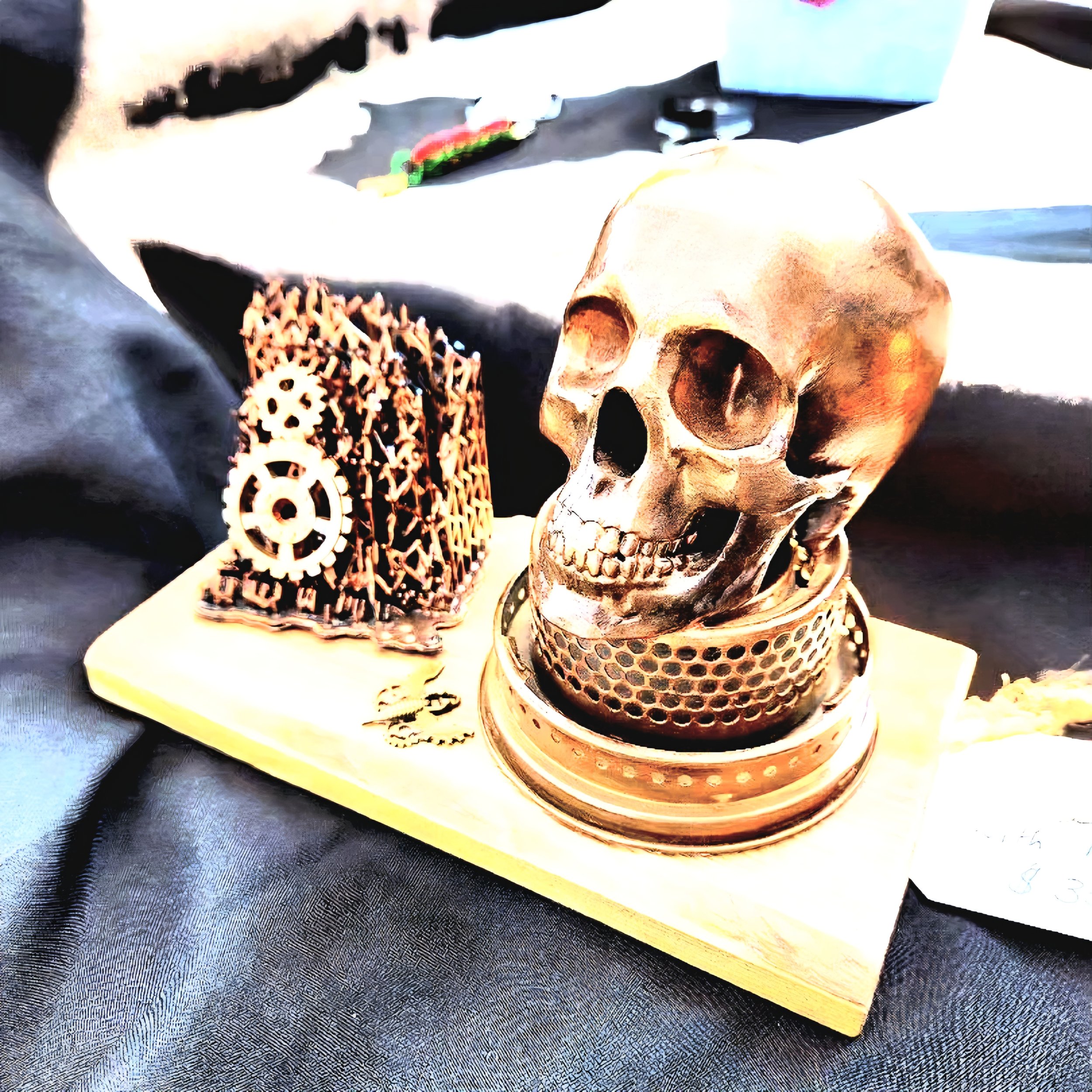 A detailed close-up of a human skull with a tea cup, surrounded by decorative gears and a patterned tablecloth, creating a macabre yet steampunk aesthetic.