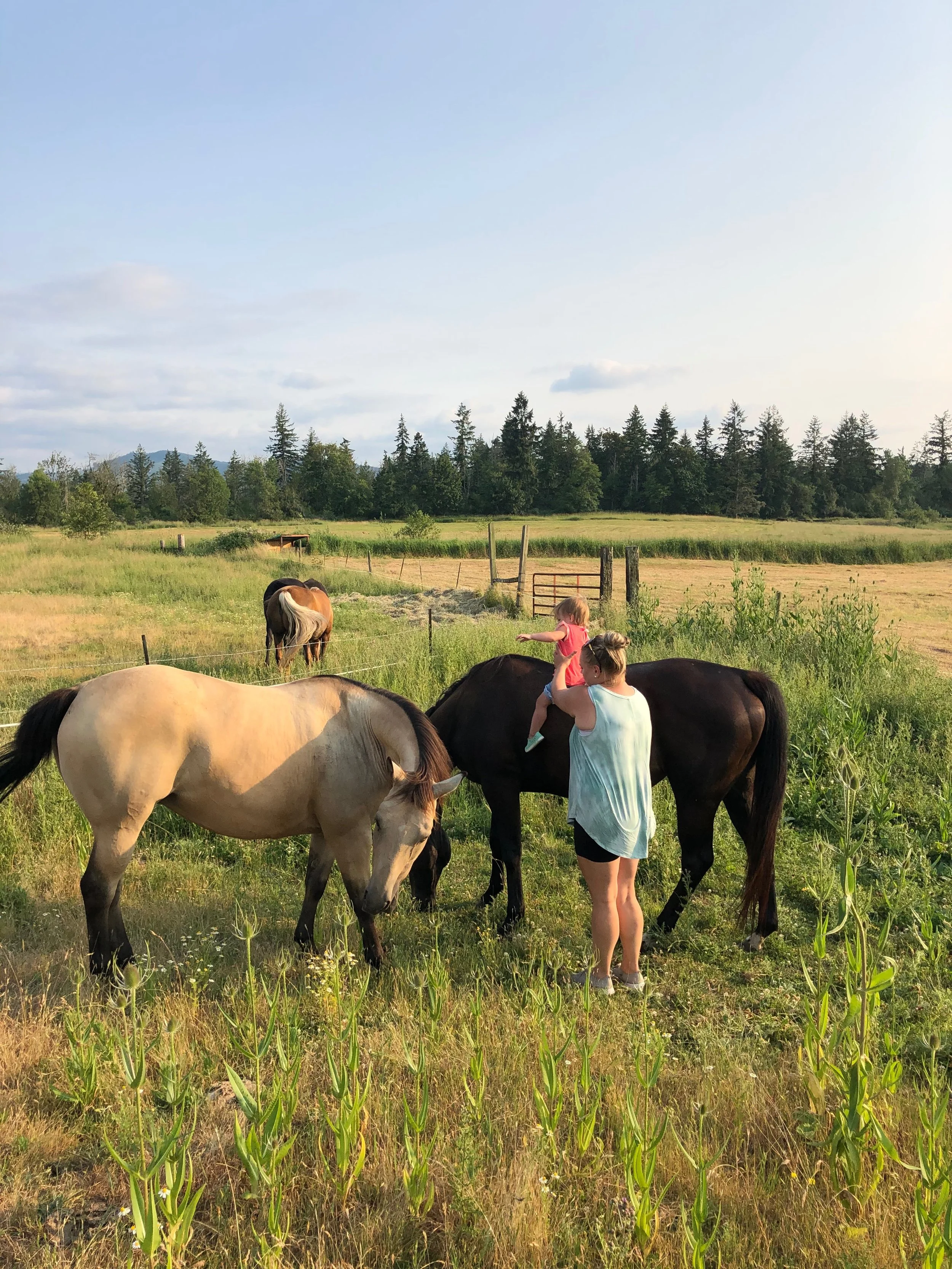 Caitie Henselman and her daughter with their horses on their rural property in Eatonville, Washington.”