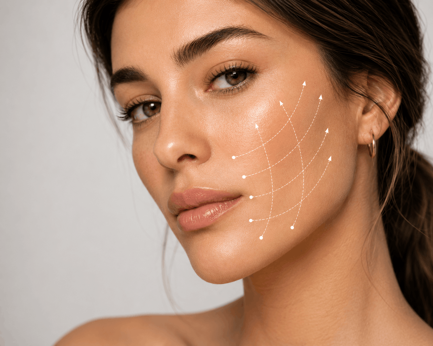 Close-up of a woman's face with a white thread outline on her face representing facial acupuncture or cosmetic acupuncture treatment.