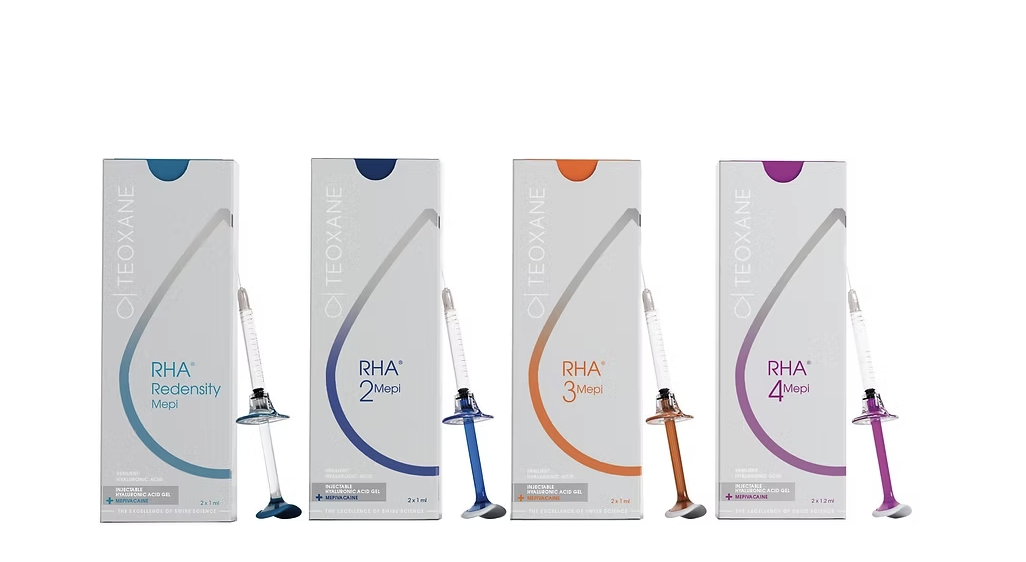 Four boxes of TEOXANE RHA dermal filler products with syringes in front of each, colored blue, dark blue, orange, and purple, indicating different formulations.