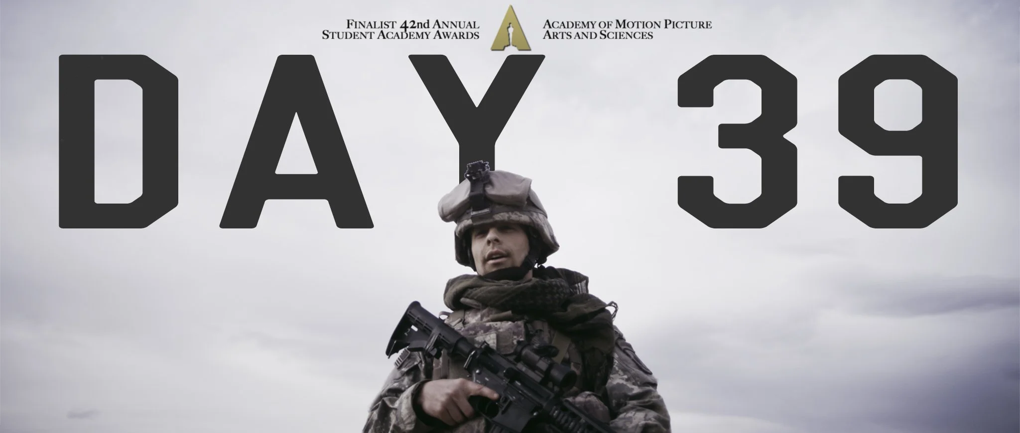 A soldier in camouflage uniform, wearing a helmet with night vision goggles, is holding a rifle and looking towards the camera. Behind him, text reads 'Day 39' in large black letters, with smaller text above indicating the 42nd Annual Student Academy Awards, the Academy of Motion Picture Arts and Sciences, and that he is a finalist.