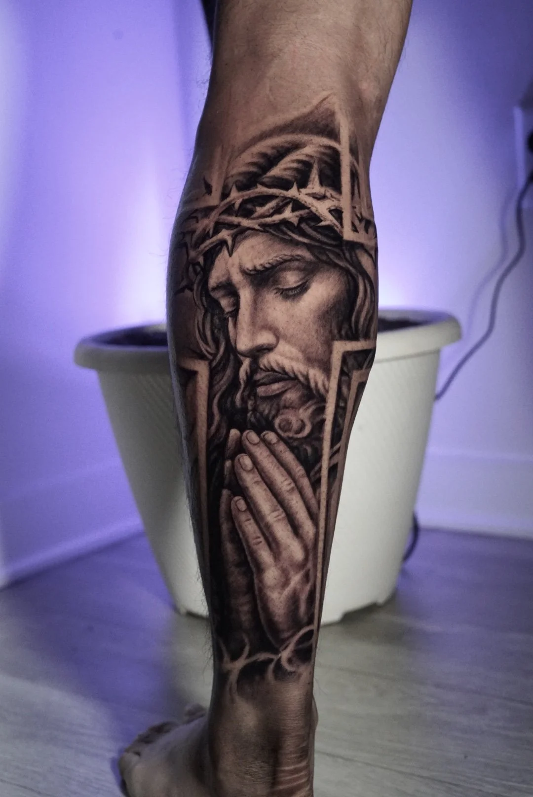 Black-and-gray praying Jesus tattoo with crown of thorns by Luis Dajer.