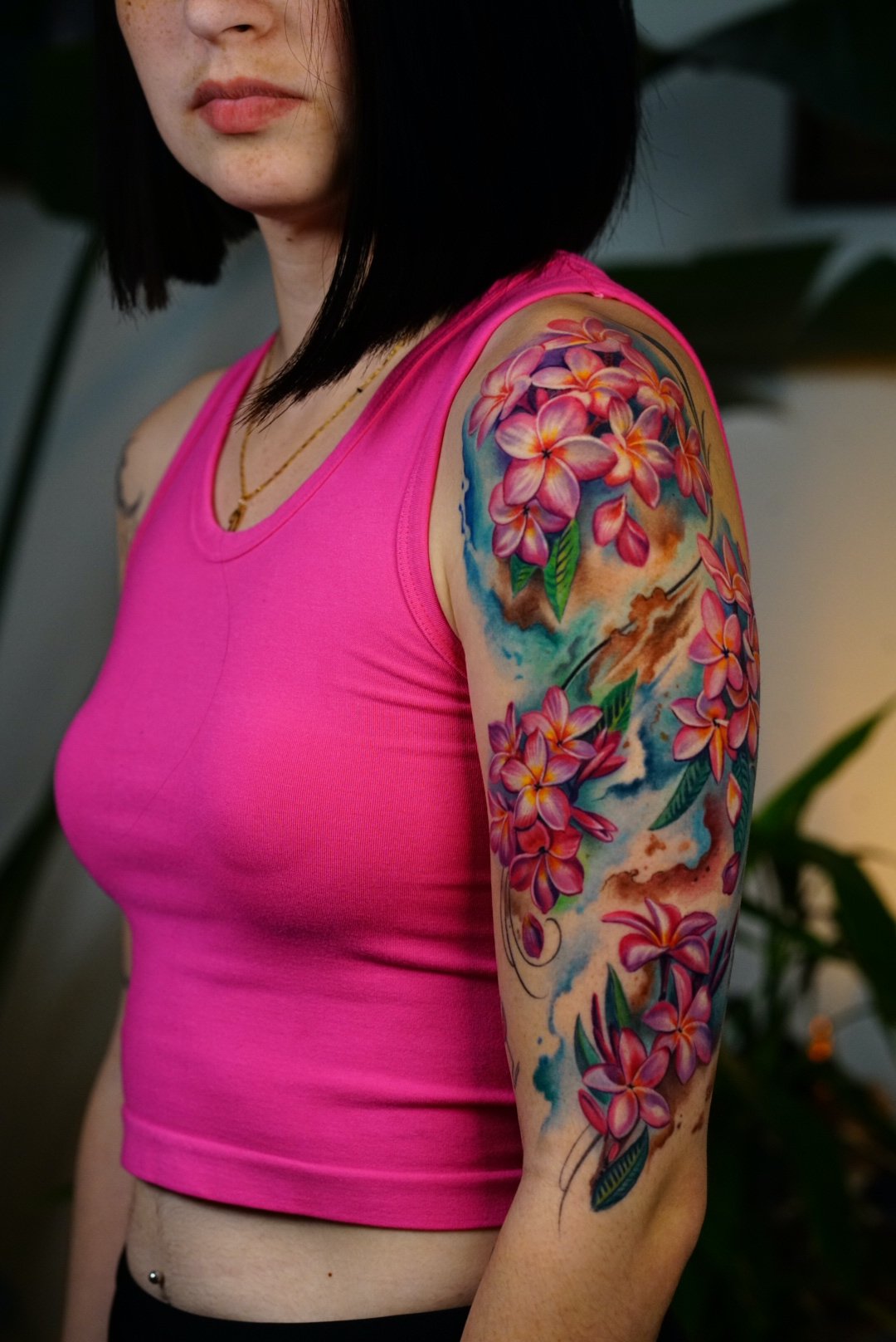 Vibrant color floral upper-arm tattoo at Black Craft Tattoo Collective.