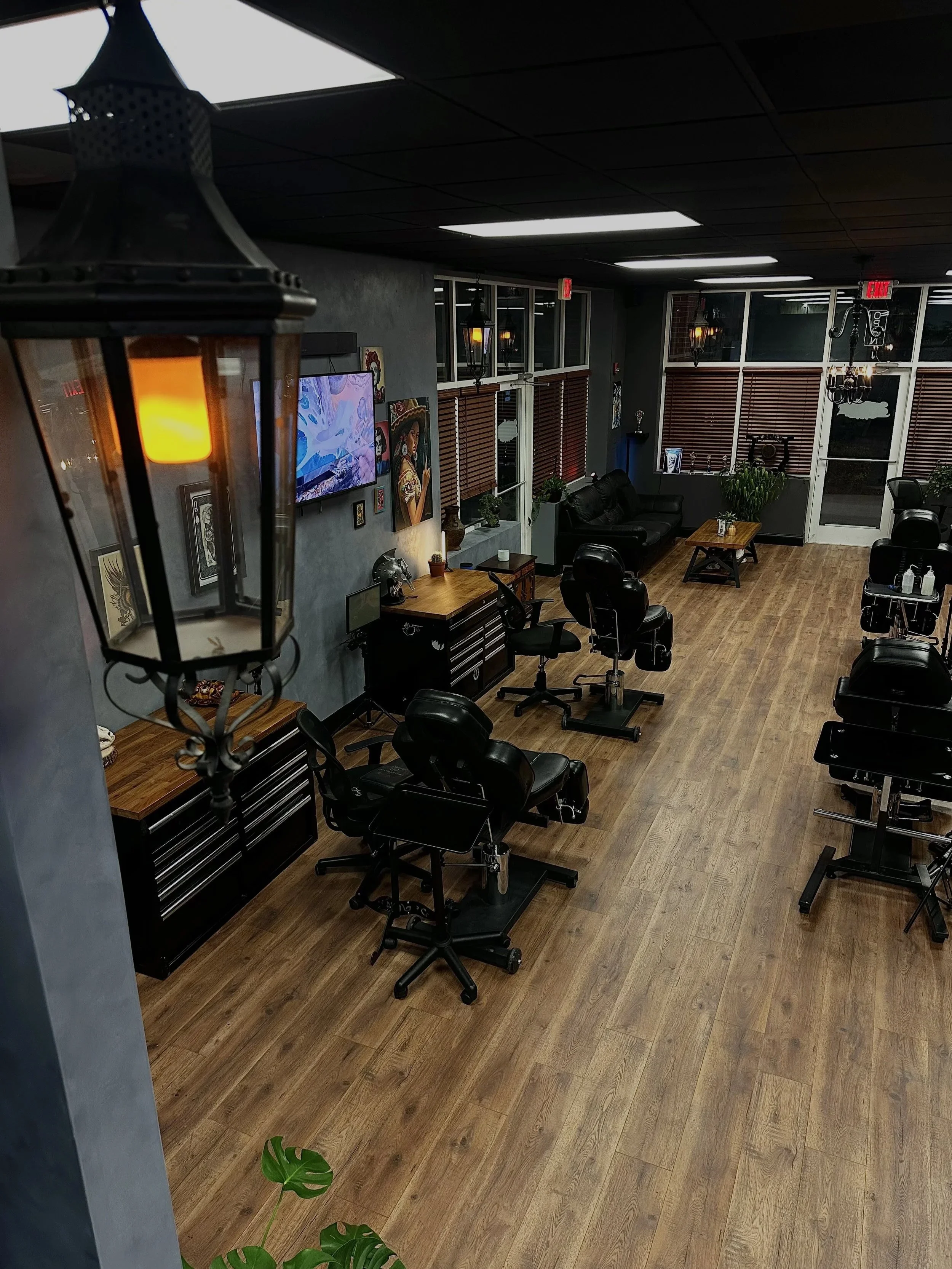 Black Craft Tattoo Collective studio interior with tattoo chairs, mirrors and artwork in Charlotte, NC.