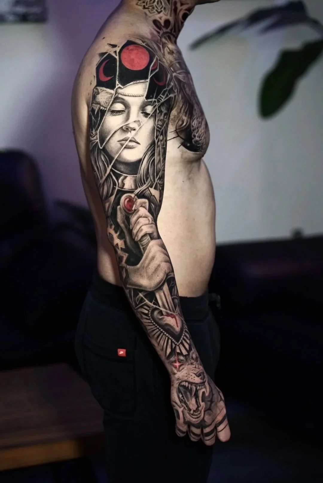 Black-and-gray full sleeve with a woman, lion, skull and abstract elements by Luis Dajer.